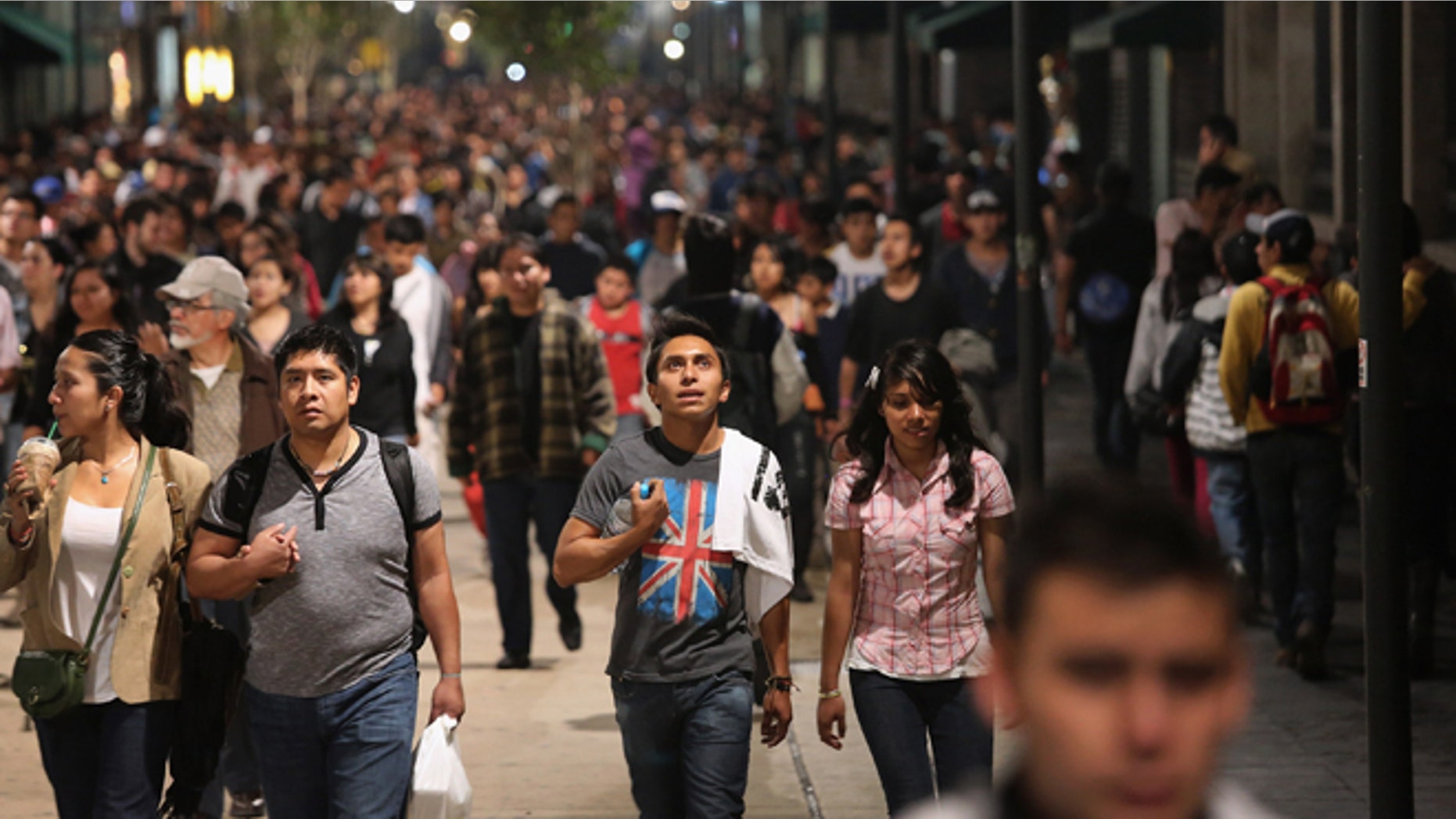 MEXICO CITY, MEXICO - JUNE 23: Mexican youth walk home after a political demonstration in Mexico City's zocalo square on June 23, 2012 in Mexico City, Mexico. Thousands of Mexican youth, most supporters of leftist presidential candidate Andres Manuel Lopez Obrador, have been demonstrating for a fair electoral process ahead of the July 1 presidential election. Lopez Obrador lost the last presidential election in 2006 by a small margin and never accepted the result, citing fraud. (Photo by John Moore/Getty Images)