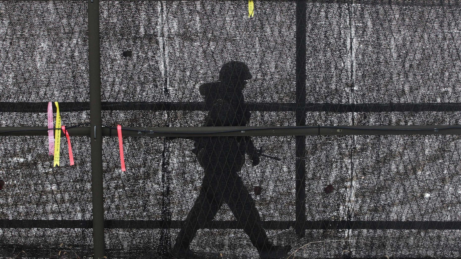 A South Korean army soldier patrols inside the barbed-wire fence at Imjingak in Paju near the demilitarized zone (DMZ) of Panmunjom, South Korea, Sunday, Feb. 17, 2013. North Korea is upgrading one of its two major missile launch sites, apparently to handle much bigger rockets, and some design features suggest it is getting help from Iran, a U.S. research institute said last Thursday. (AP Photo/Ahn Young-joon)