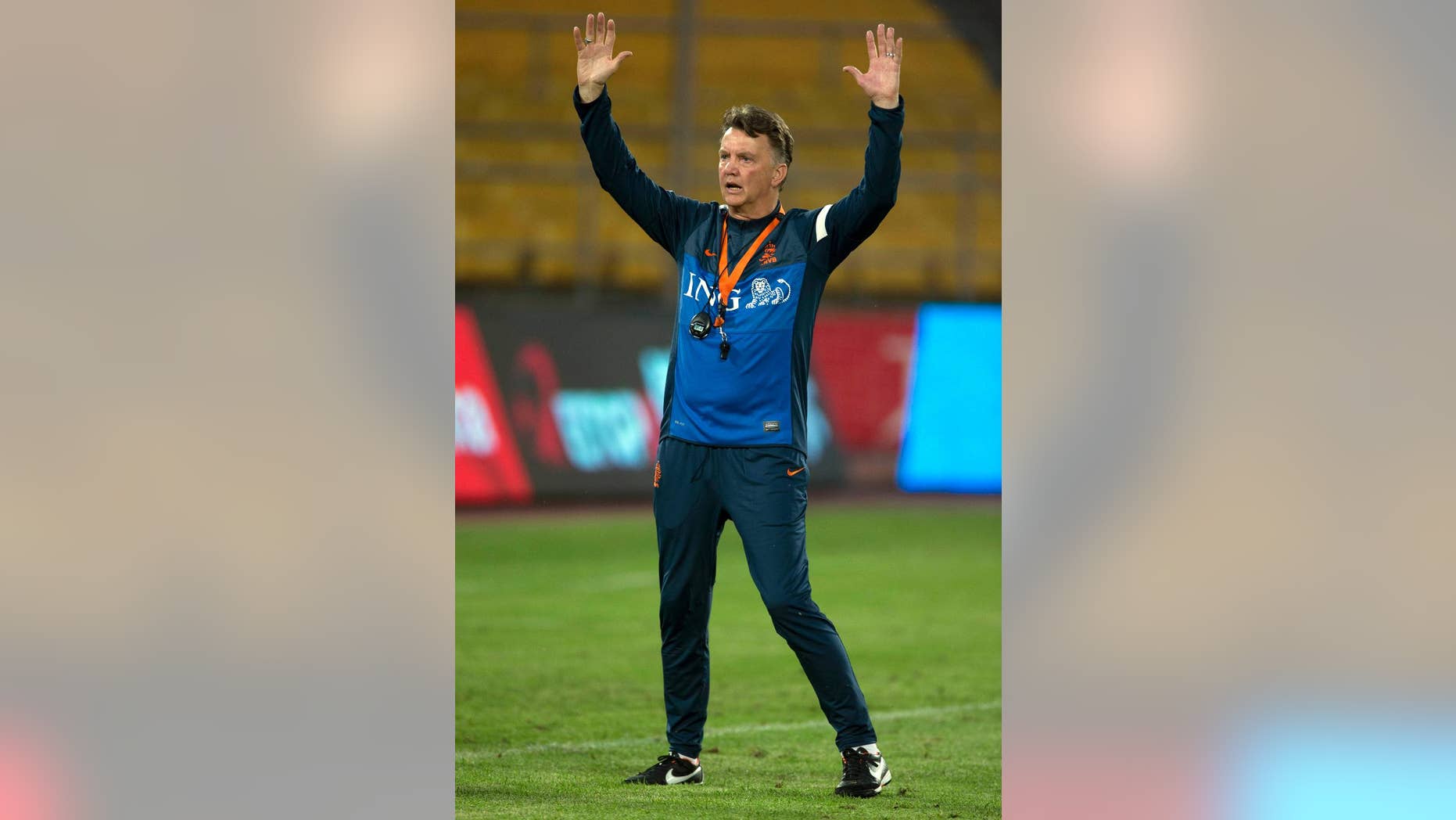 FILE - In this June 10, 2013,file photo Netherlands' coach Louis van Gaal gestures during practice, a day before a friendly soccer match against the Chinese national team at the Worker's Stadium in Beijing, China. Van Gaal, who will be replaced by Guus Hiddink after the tournament, has rebuilt the team to play more attractive attacking football. (AP Photo/Ng Han Guan, File)
