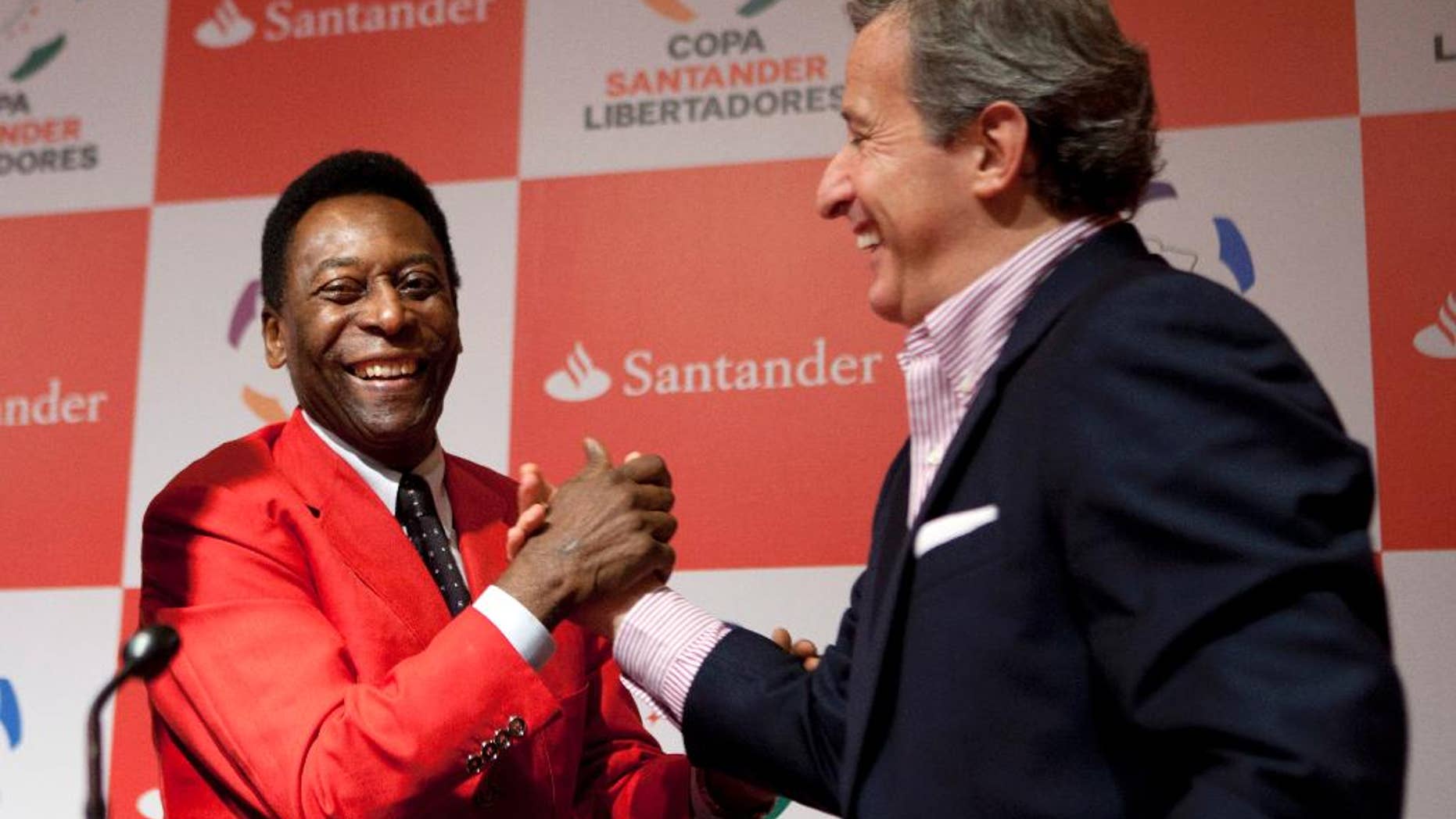 FILE - In this Wednesday, June 22, 2011 file photo, Juan Pedro Damiani, president of Uruguay's Penarol soccer club, right, shakes hands with Brazilian soccer legend Pele after a news conference in Sao Paulo, Brazil. Under suspicion in the fallout from the global offshore accounts investigation, Uruguayan lawyer Juan Pedro Damiani resigned as a FIFA ethics judge on Wednesday April 6, 2016. (AP Photo/Victor R. Caivano, file)