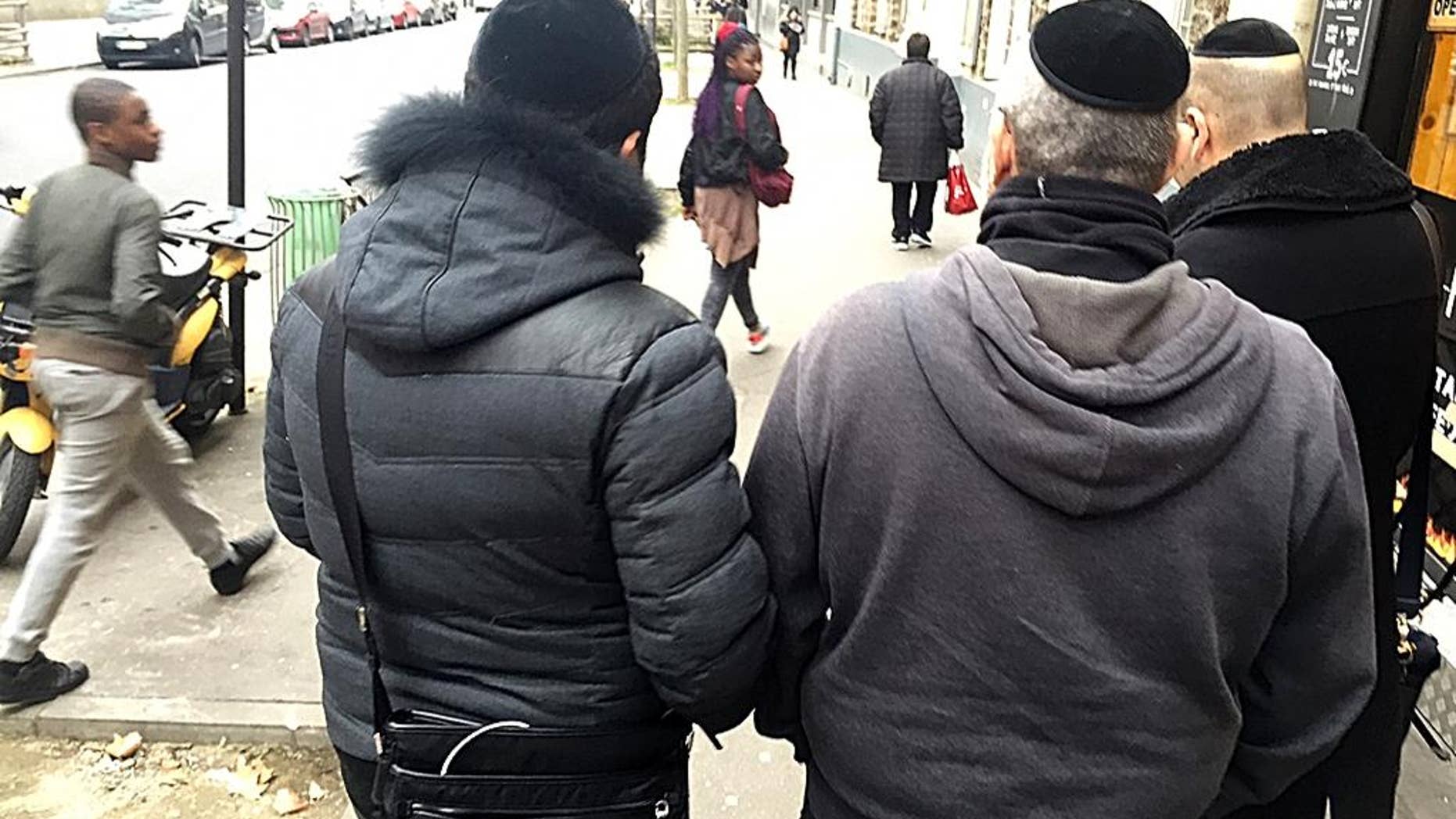Members of France's Jewish community wear kippahs while walking the streets of Paris.