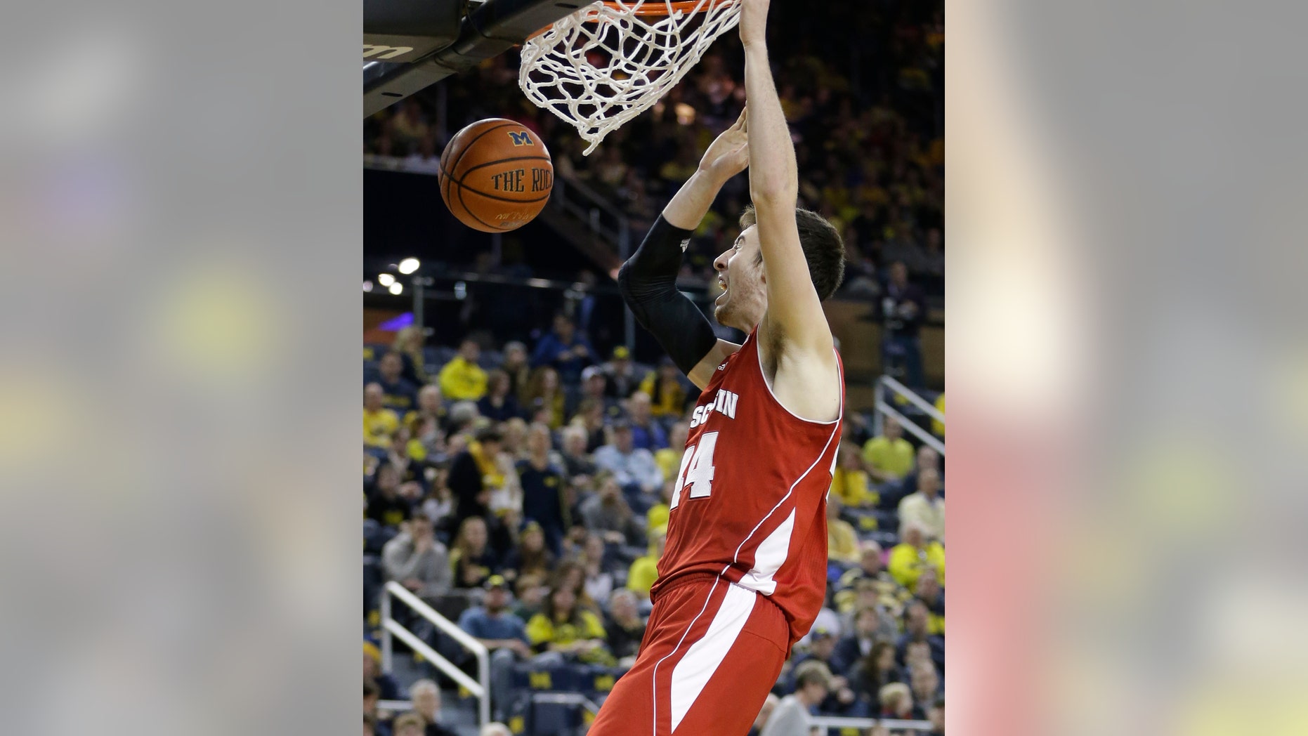 Wisconsin forward Frank Kaminsky (44) dunks during the second half of an NCAA college basketball game against Michigan in Ann Arbor, Mich., Sunday, Feb. 16, 2014. Kaminsky finished with 25 points in the Badgers 75-62 win. (AP Photo/Carlos Osorio)