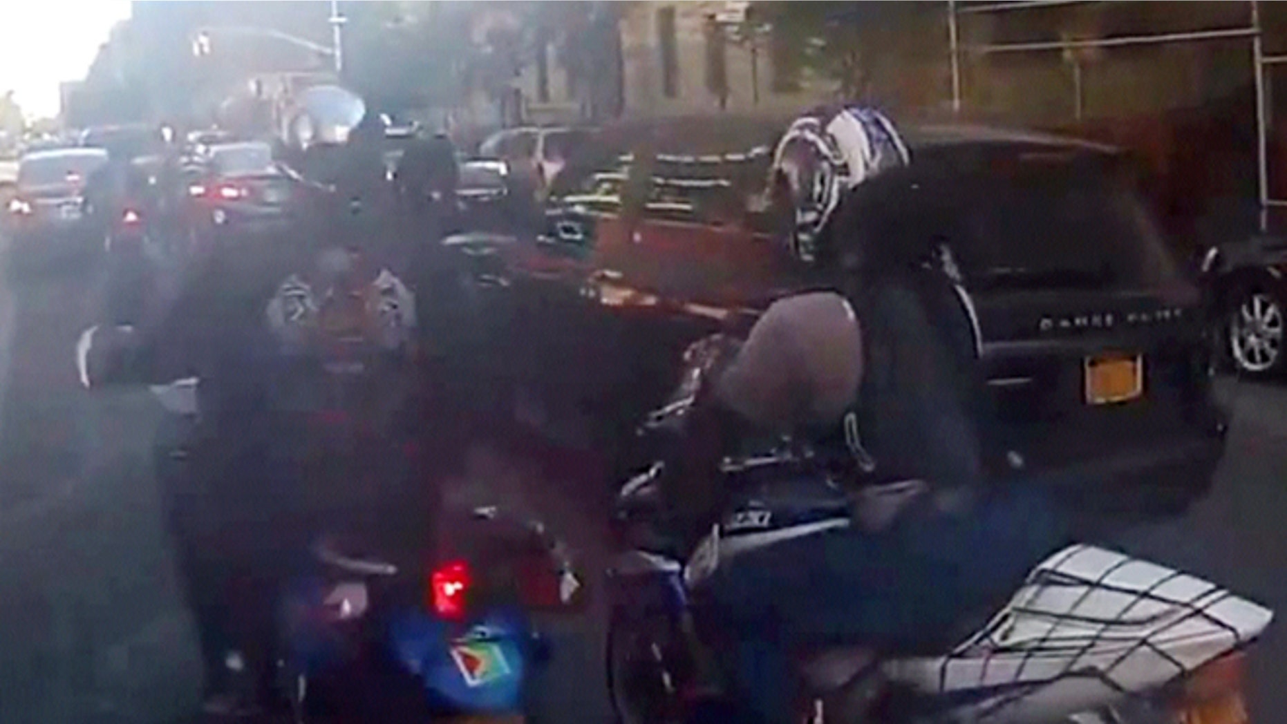 Motorcyclists ride alongside Alexian Lien's sport utility vehicle, Sunday, Sept. 29, 2013, in New York.