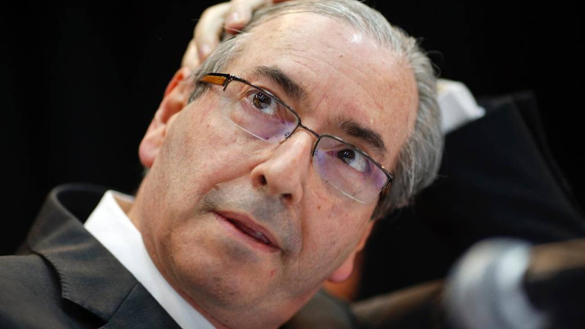 FILE - In this Aug.21, 2015 file photo, Eduardo Cunha, president of Brazil's Chamber of Deputies, attends a meeting with union workers in Sao Paulo, Brazil. Brazil's Supreme Court seized $2.45 million in Swiss accounts allegedly belonging to Cunha, a powerful political figure who can largely determine whether widely sought impeachment proceedings against President Dilma Rousseff are introduced on the chamber floor. Cunha is facing corruption charges in a huge kickback scheme at state-run oil company Petrobras. (AP Photo/Andre Penner, File)