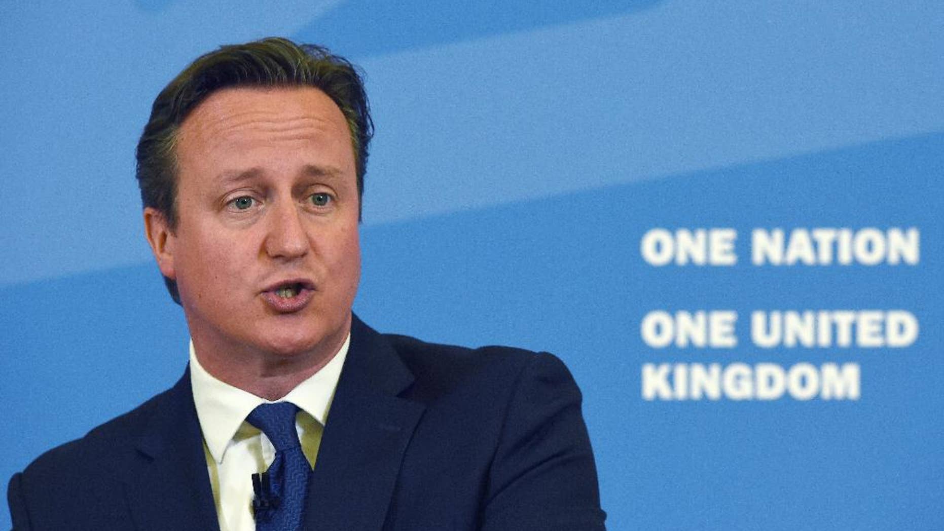 Britain's Prime Minister David Cameron delivers a speech, where he said that new Government legislation will include powers to put non-violent extremists who radicalize young people "out of action", at Ninestiles Academy in Birmingham, England, Monday, July 20, 2015. Cameron is launching a five-year plan to defeat Islamic extremism, saying it's time to counter the ideology that has attracted so many young people to the Islamic State group. In what is being billed as his most important speech on the subject, Cameron says the extremist ideology of the group, also known as ISIL, must be countered so Britain becomes a more cohesive nation in which young Muslims feel they have a stake. (Paul Ellis/PA via AP) UNITED KINGDOM OUT - NO SALES - NO ARCHIVES