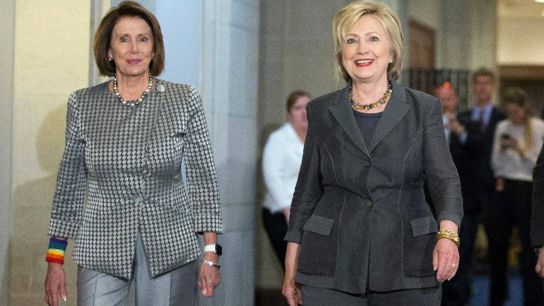 Then-Democratic presidential candidate Hillary Clinton walks with House Minority Leader Nancy Pelosi of Calif. as they arrive for a meeting with the House Democratic Caucus, Wednesday, June 22, 2016, on Capitol Hill in Washington. (AP Photo/Alex Brandon)