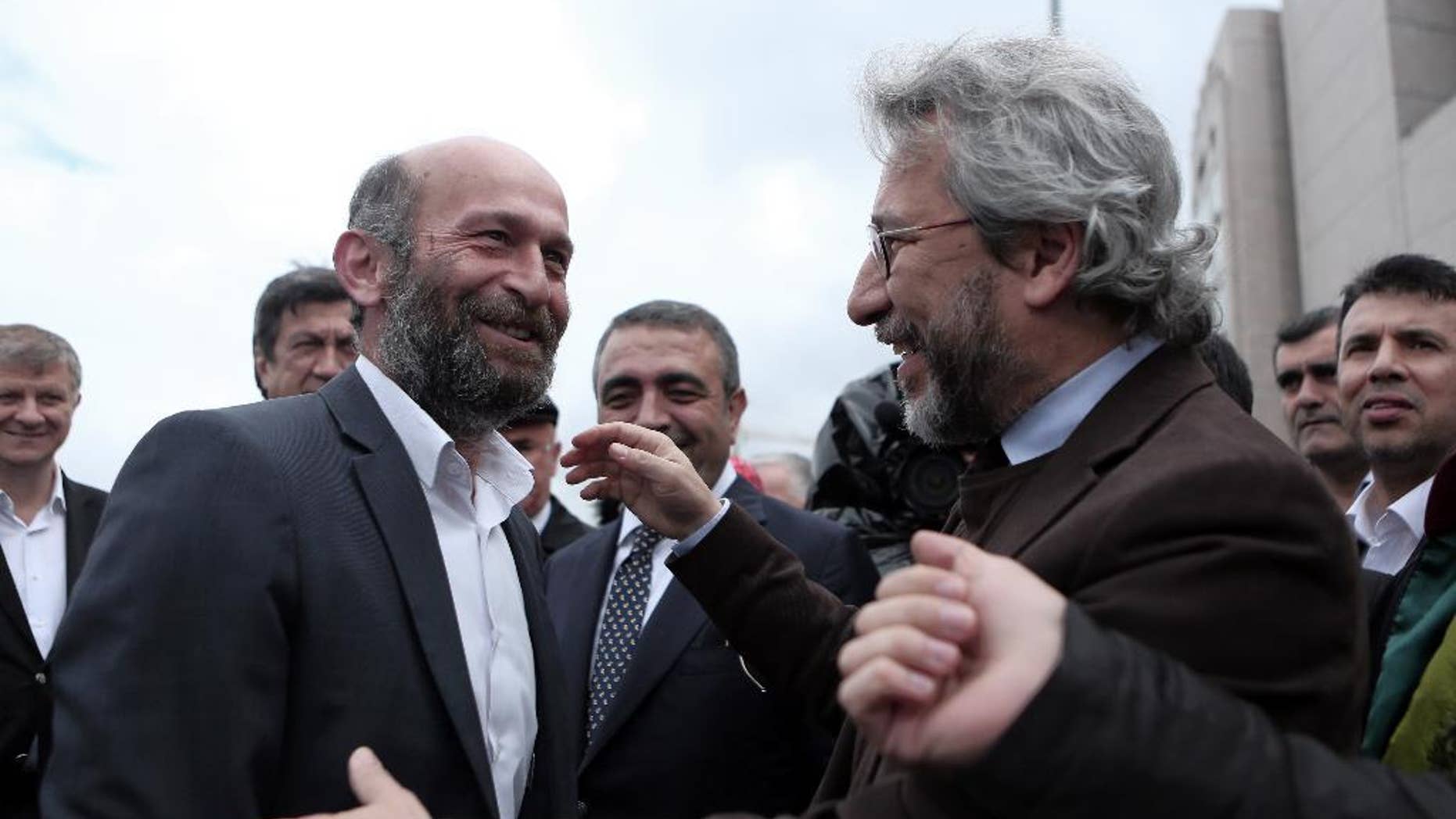 FILE - In this Friday, May 6, 2016 file photo, journalists Can Dundar, right, and Erdem Gul, Ankara Bureau Chief of Cumhuriyet newspaper, speak before the start of their trial, hours before the attack on Can Dundar outside city's main courthouse in Istanbul. Two opposition journalists went on trial in Turkey for a second time on Wednesday, Sept. 21, 2016 accused of aiding the movement led by U.S.-based cleric Fethullah Gulen that the government has branded a terror organization. (Can Erok, Cumhuriyet via AP, File) TURKEY OUT