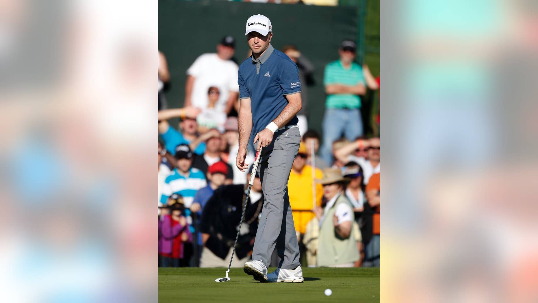 Martin Laird reacts after missing a birdie putt that would have put him in a tie for the lead on the 18th hole during the final round of the Phoenix Open golf tournament, Sunday, Feb. 1, 2015, in Scottsdale, Ariz. (AP Photo/Rick Scuteri)