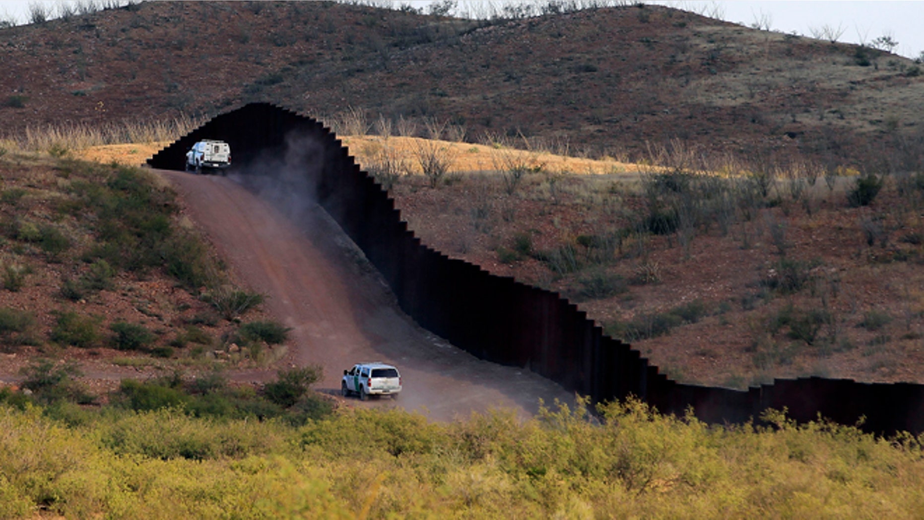 U.S. Border Patrol agents patrol the border fence near where a U.S. Border Patrol agent Nicholas Ivie was shot and killed, and one other was shot and injured, in Naco, Arizona