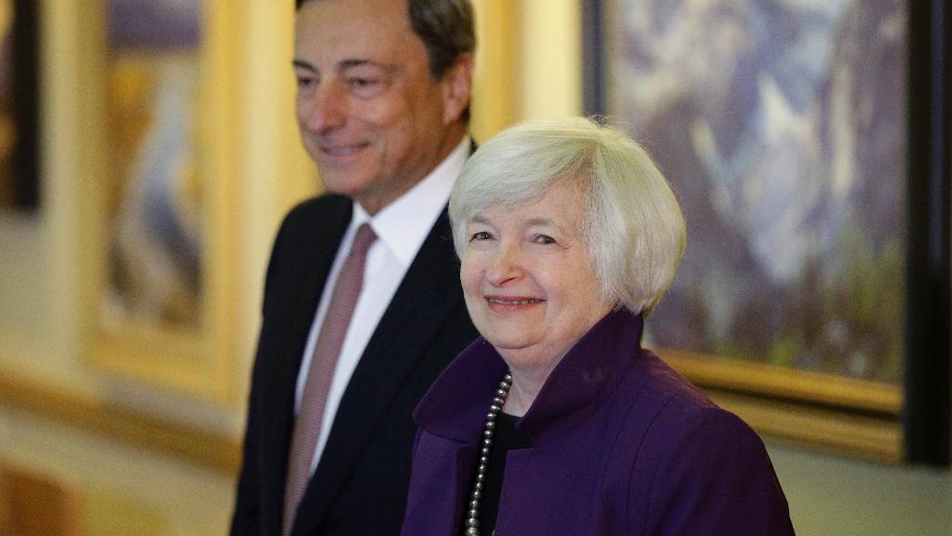 FILE - In this Aug. 22, 2014 file photo, Federal Reserve Chair Janet Yellen, right, and European Central Bank President Mario Draghi walk together during the Jackson Hole Economic Policy Symposium at the Jackson Lake Lodge in Grand Teton National Park near Jackson, Wyo. Record low interest rates were meant to be a temporary response to the global financial crisis. But eight years later, rates are still near zero in much of the developed world - and some experts are warning of long-term side effects. The Federal Reserve lowered its short-term benchmark - which determines the cost of overnight lending between banks - to between zero and 0.25 percent in December 2008. The European Central Bank reached zero in March and the Bank of Japan in late 2010. Just last week, the Bank of England cut its benchmark rate to 0.25 percent and indicated it could bring it closer to zero. (AP Photo/John Locher, file)