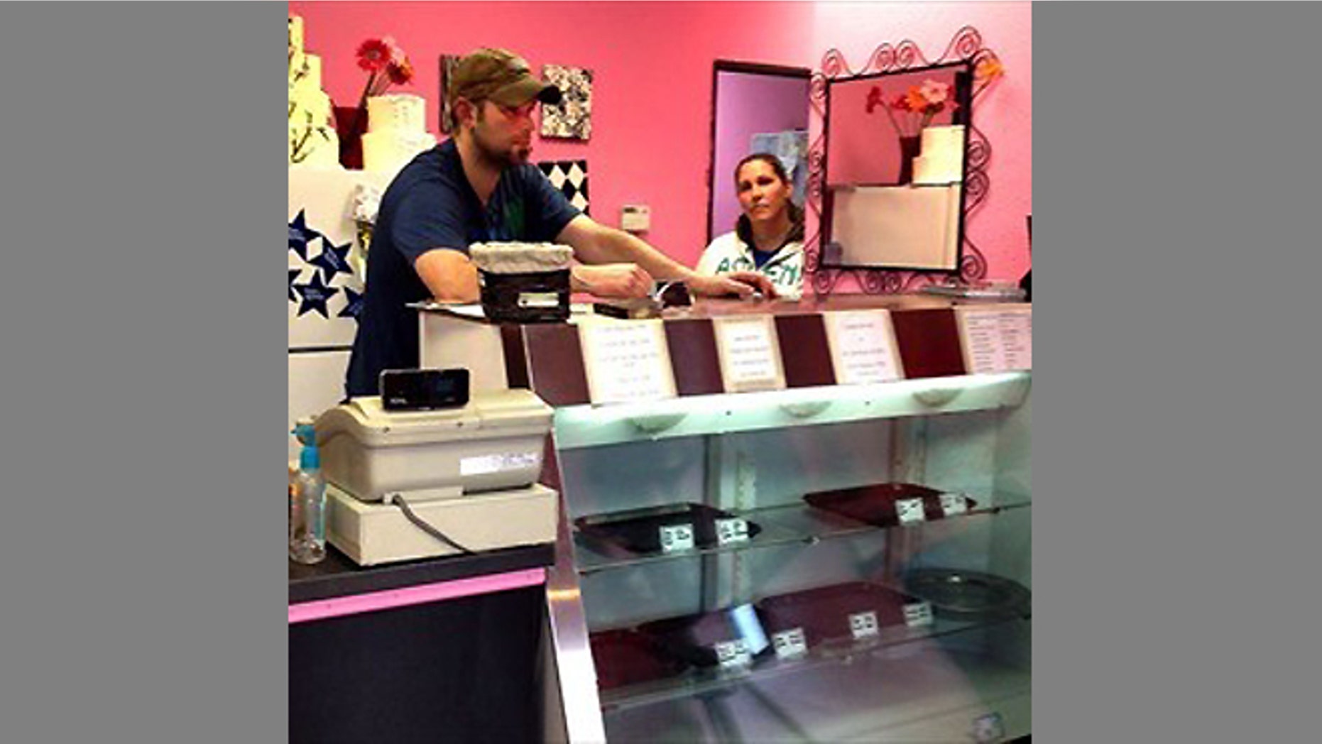FILE - In this undated photograph Aaron Klein stands behind the counter of his Oregon bakery, Sweet Cakes by Melissa. Since this photo was taken the store has closed. The Kleins now operate their bakery business out of their home.