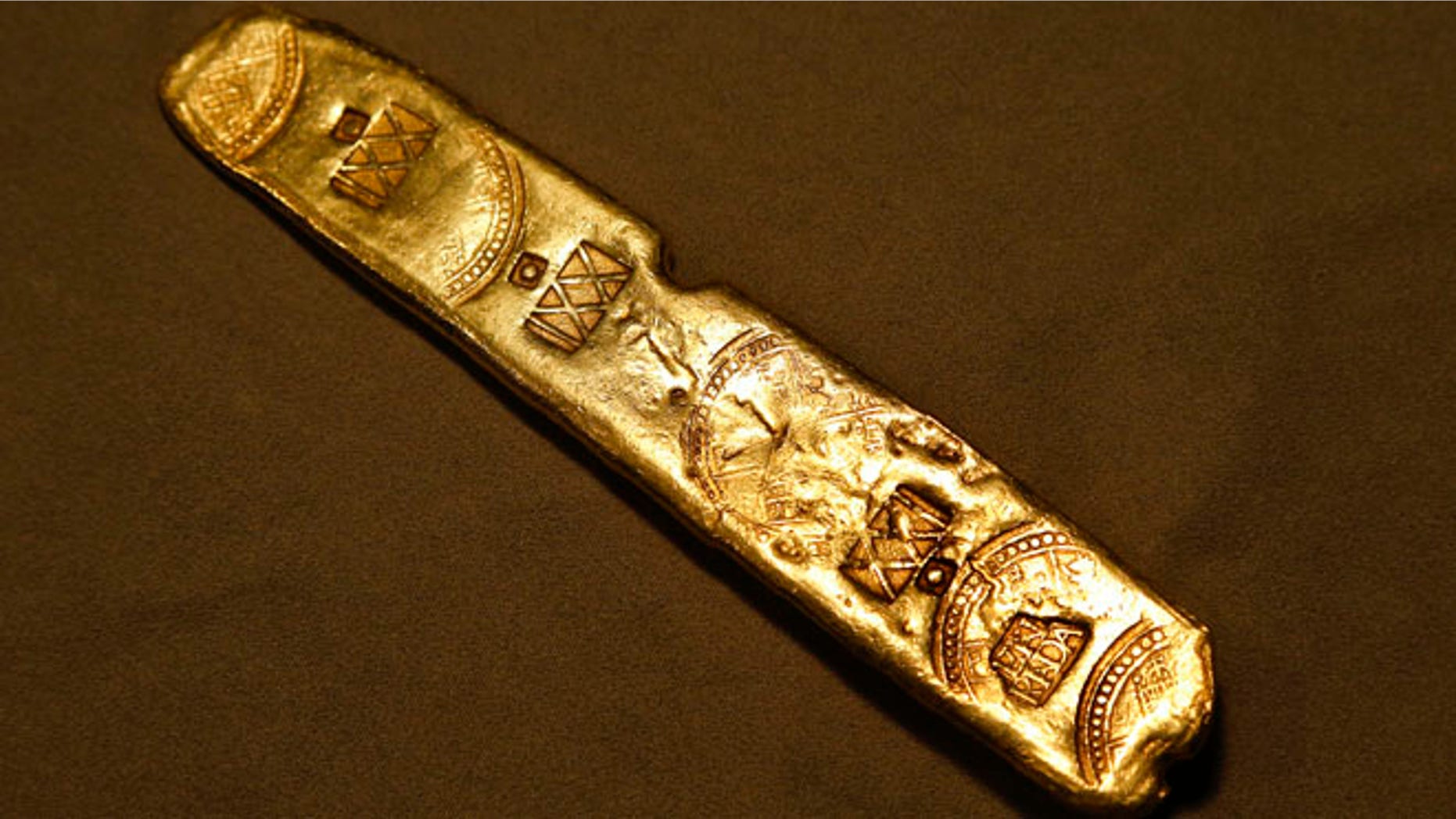 FILE - This June 18, 2015 file photo shows a gold bar on display in New York. It was one of many items pulled from the 400-year-old Spanish galleon Nuestra Senora de Atocha wreckage that were auctioned off by Guernsey's for about $2 million, Wednesday Aug. 5, 2015. (AP Photo/Julie Jacobson, File)