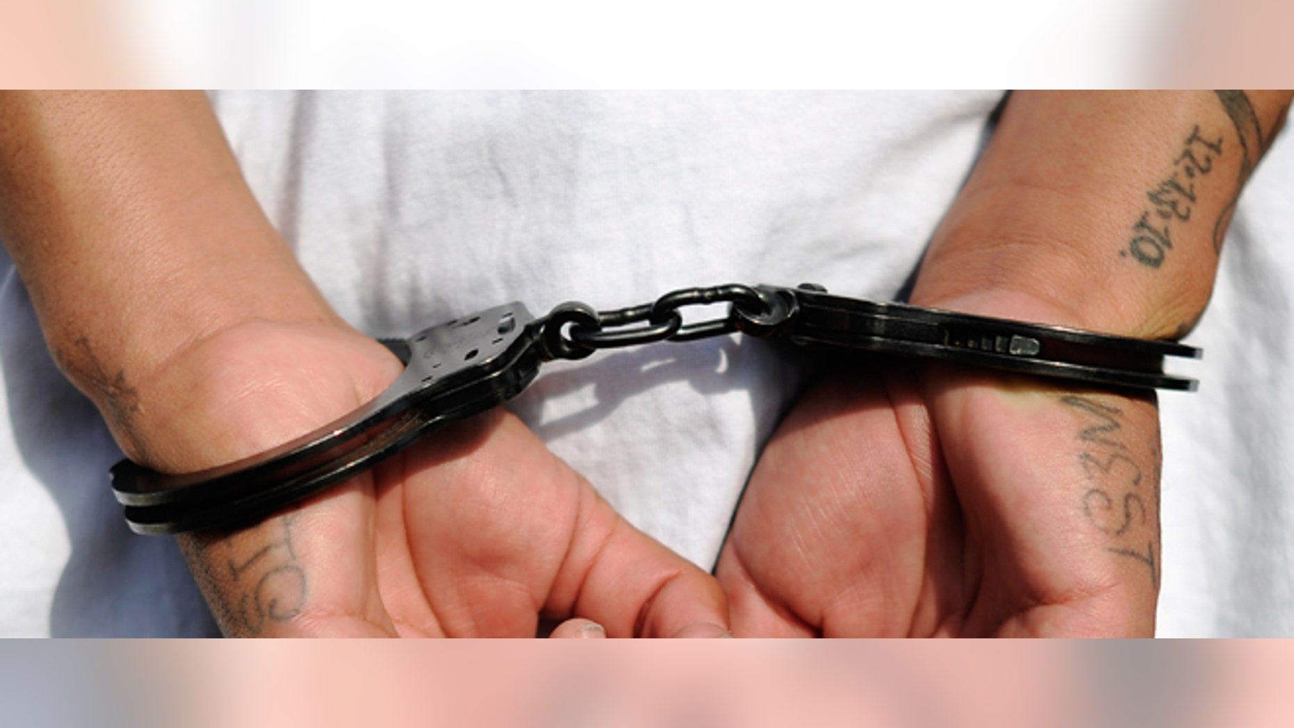LOS ANGELES, CA - APRIL 29: Handcuffs are seen on the hands of a twenty-year old "Street Villains" gang member who was arrested by Los Angeles Police Department officers from the 77th Street division on April 29, 2012 in Los Angeles, California. The 77th Street division patrol the same neighborhood that truck driver Reginald Denny was nearly beaten to death by a group of black assailants at the intersection of Florence and Normandie Avenues. It?s been 20 years since the verdict was handed down in the Rodney King case that sparked infamous Los Angeles riots. (Photo by Kevork Djansezian/Getty Images)