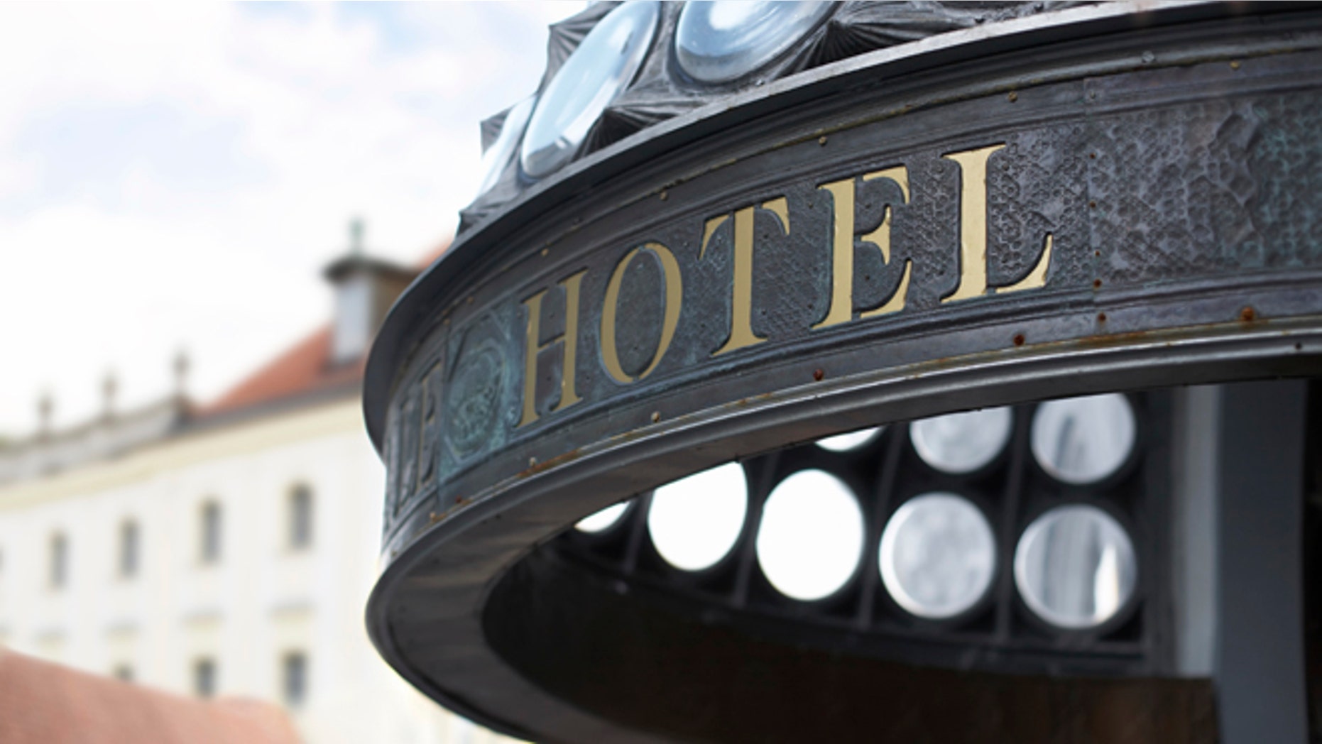 Close up of hotel header incription. Golden letters. Shallow DOF.