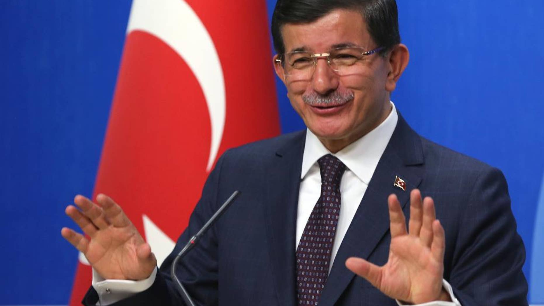 Turkish Prime Minister and leader of Justice and Development Party Ahmet Davutoglu speaks to the media after a meeting with Kemal Kilicdaroglu, the leader of the main opposition Republican People's Party, CHP, in Ankara, Turkey, Monday, July 13. 2015. Davutoglu has begun a first round of talks on forming a coalition government by meeting officials of Turkey’s secularist party, CHP, his ruling Islamic-rooted party’s arch-foe. Davutoglu met with Kilicdaroglu on Monday, a month after Turkey’s June 7 election left his party short of a majority, forcing it to seek a coalition alliance.(AP Photo/Burhan Ozbilici)