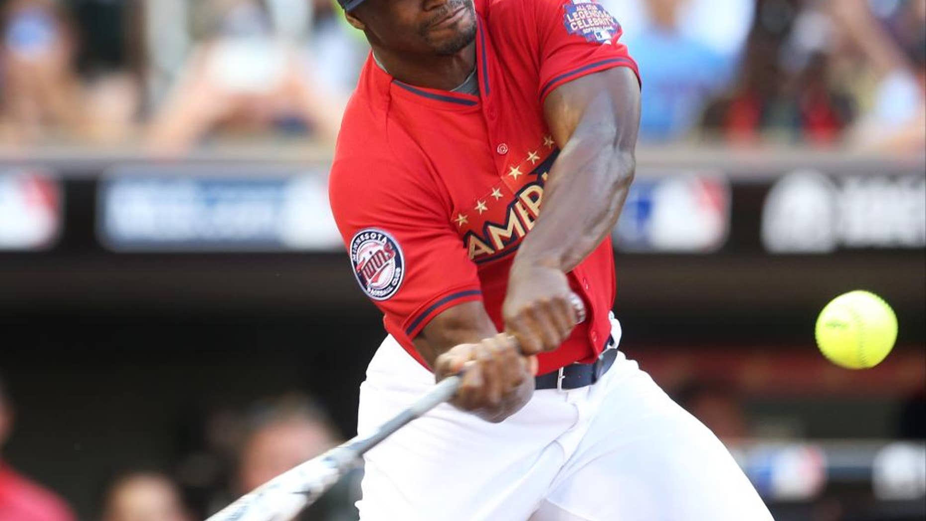 Minnesota Vikings running back Adrian Peterson bats during the All-Star Legends & Celebrity Softball Game, Sunday, July 13, 2014, in Minneapolis. (AP Photo/Jim Mone)