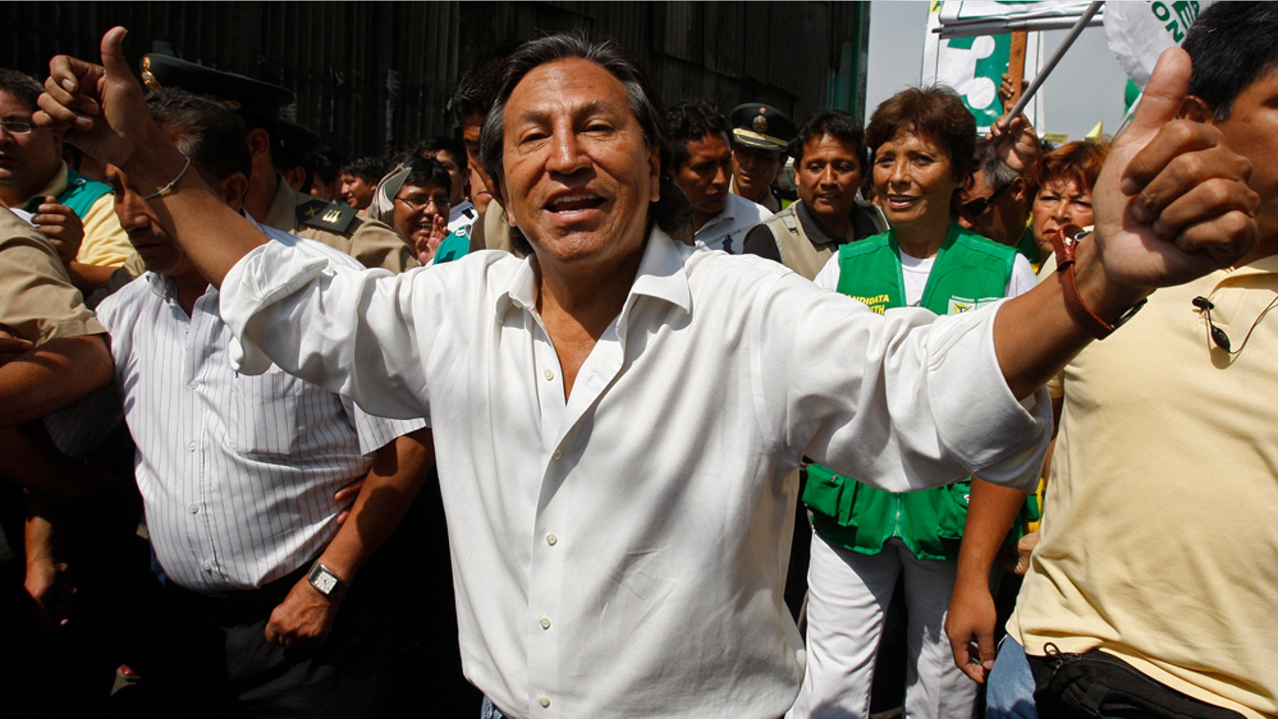 Peru's former President Alejandro Toledo campaigns for reelection at the Santa Anita wholesale market in Lima, Peru, Thursday March 17, 2011. Peru will hold general elections on April 10. (AP Photo/Karel Navarro)
