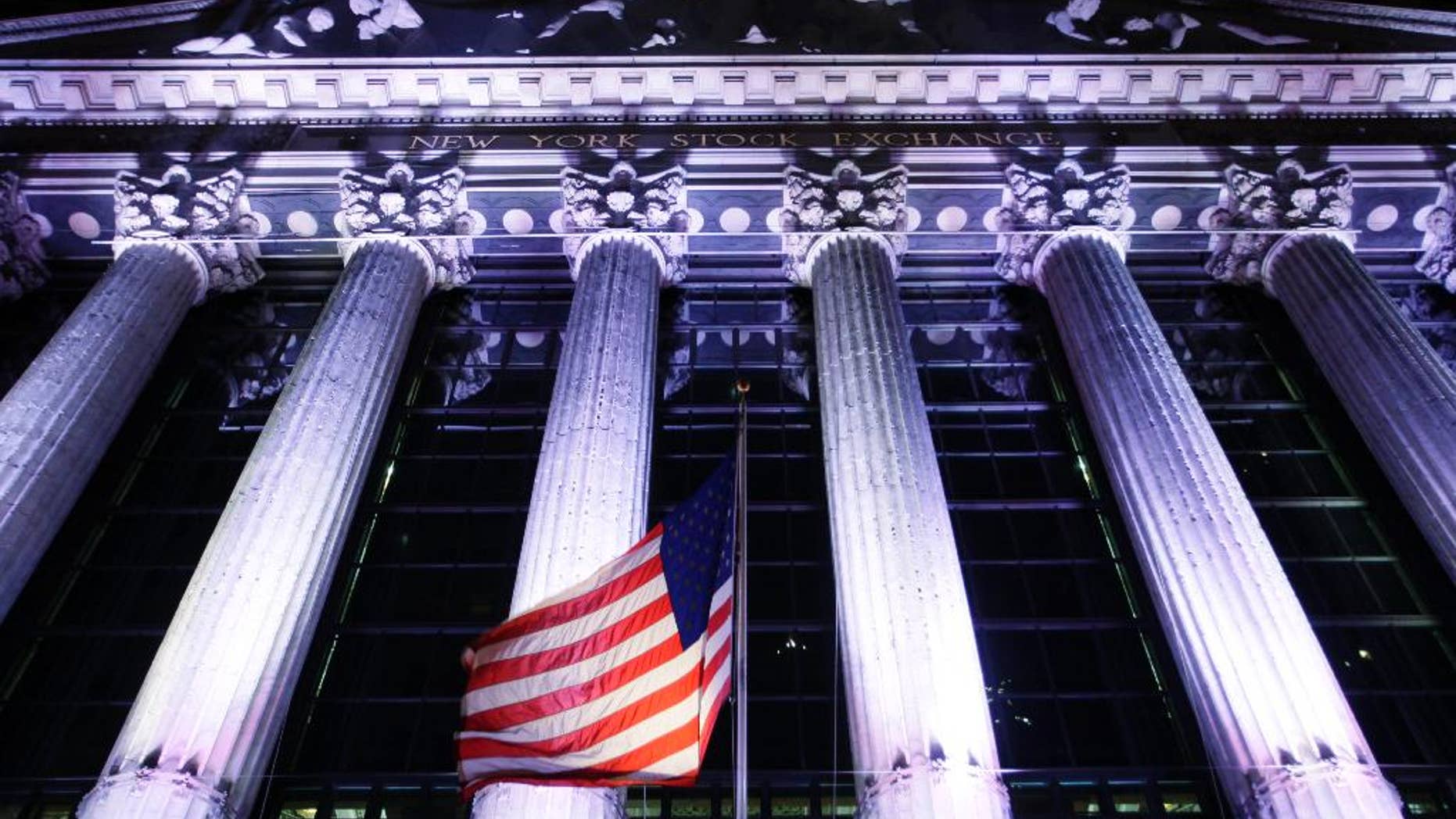 In this Oct. 8, 2014 photo, an American flag flies in front of the New York Stock Exchange in New York. U.S. stocks are plunging in early trading Wednesday, Oct. 15, 2014, as traders flee risky assets. (AP Photo/Mark Lennihan)