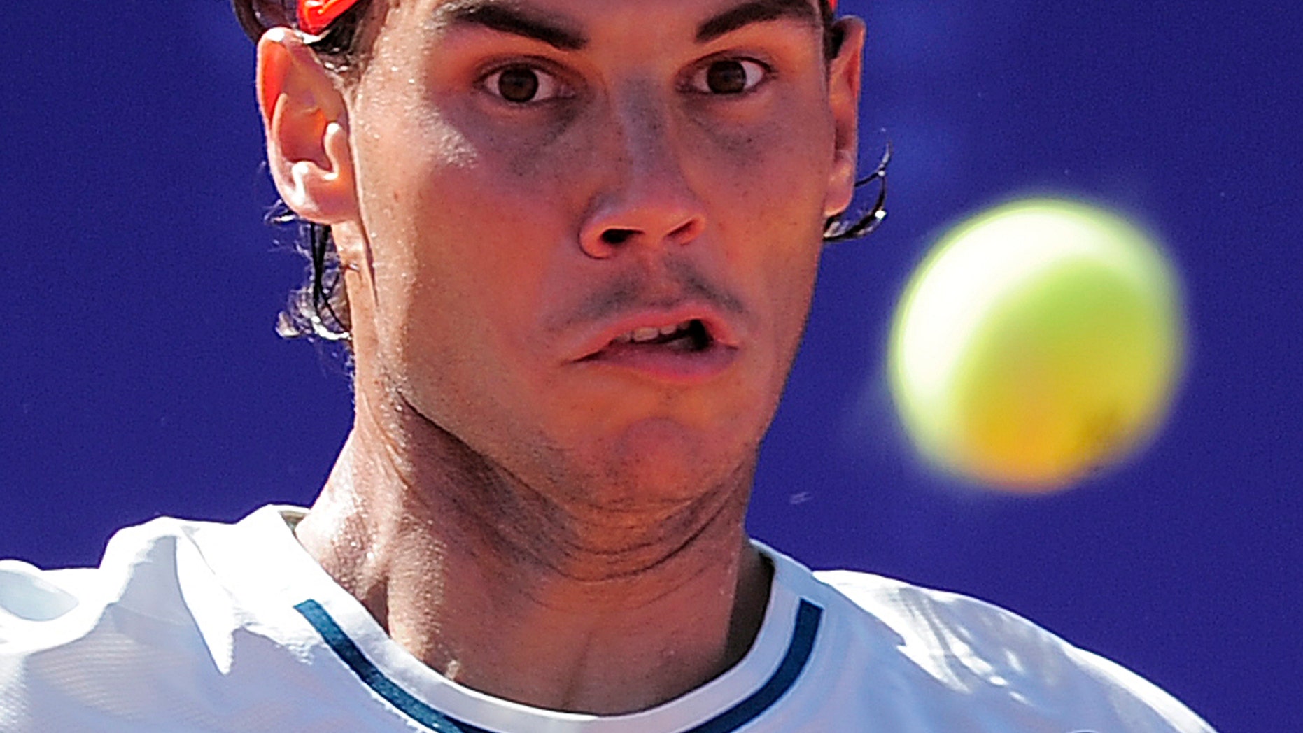 Rafael Nadal of Spain looks the ball against Carlos Berlocq, from Argentina, during the Barcelona open tennis in Barcelona, Spain, Wednesday, April 24, 2013. Nadal won 6-4, 6-2. (AP Photo/Manu Fernandez)