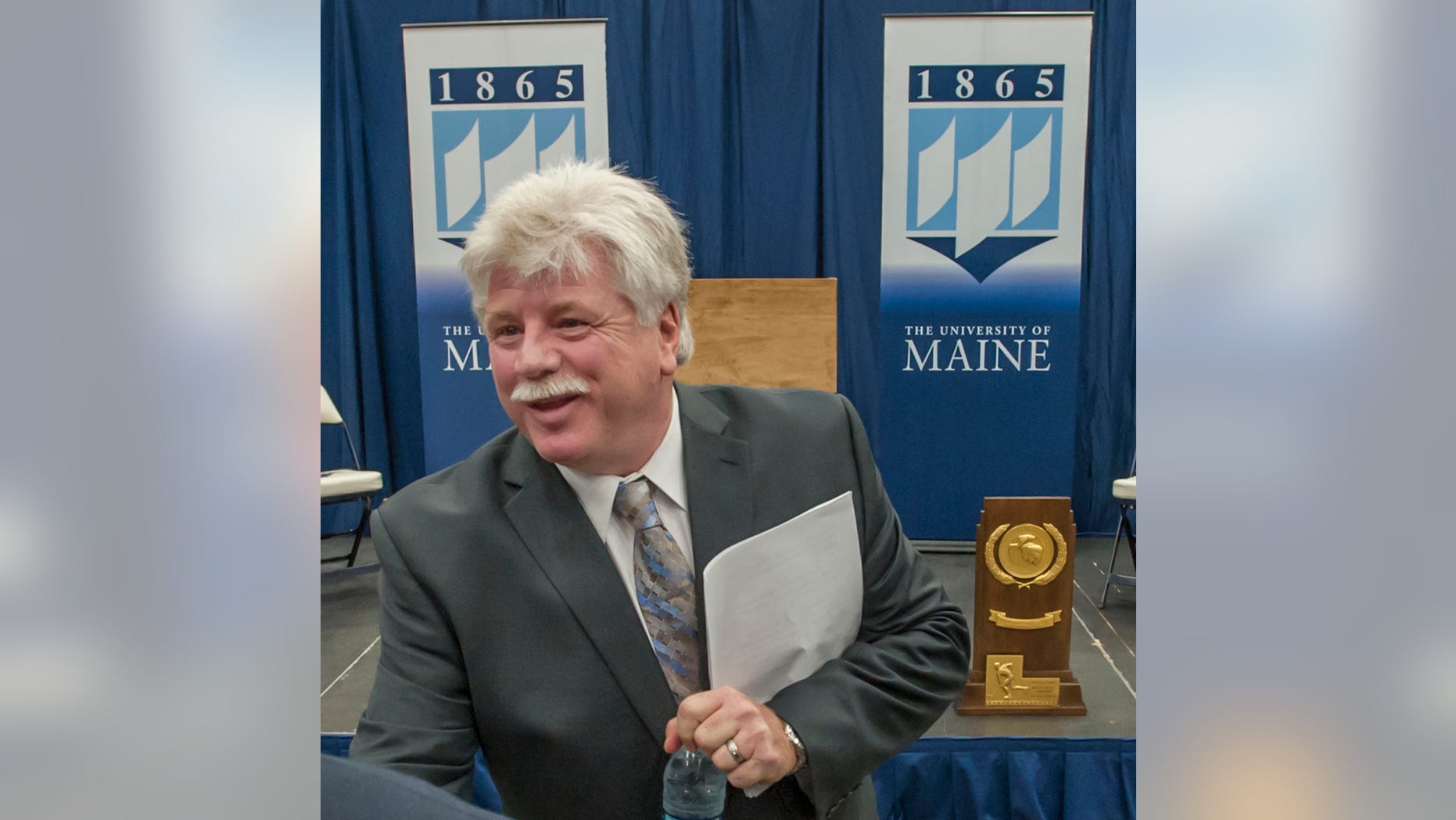 FILE - In this May 28, 2013 file photo, Dennis "Red" Gendron speaks to well-wishers after being introduced as the new men's hockey coach at the University of Maine, in Orono, Maine. Gendron has coached championship hockey teams in high school, college and the NHL. The hockey faithful are hoping he can now restore the luster to the University of Maine hockey program. (AP Photo/Michael C. York, File)