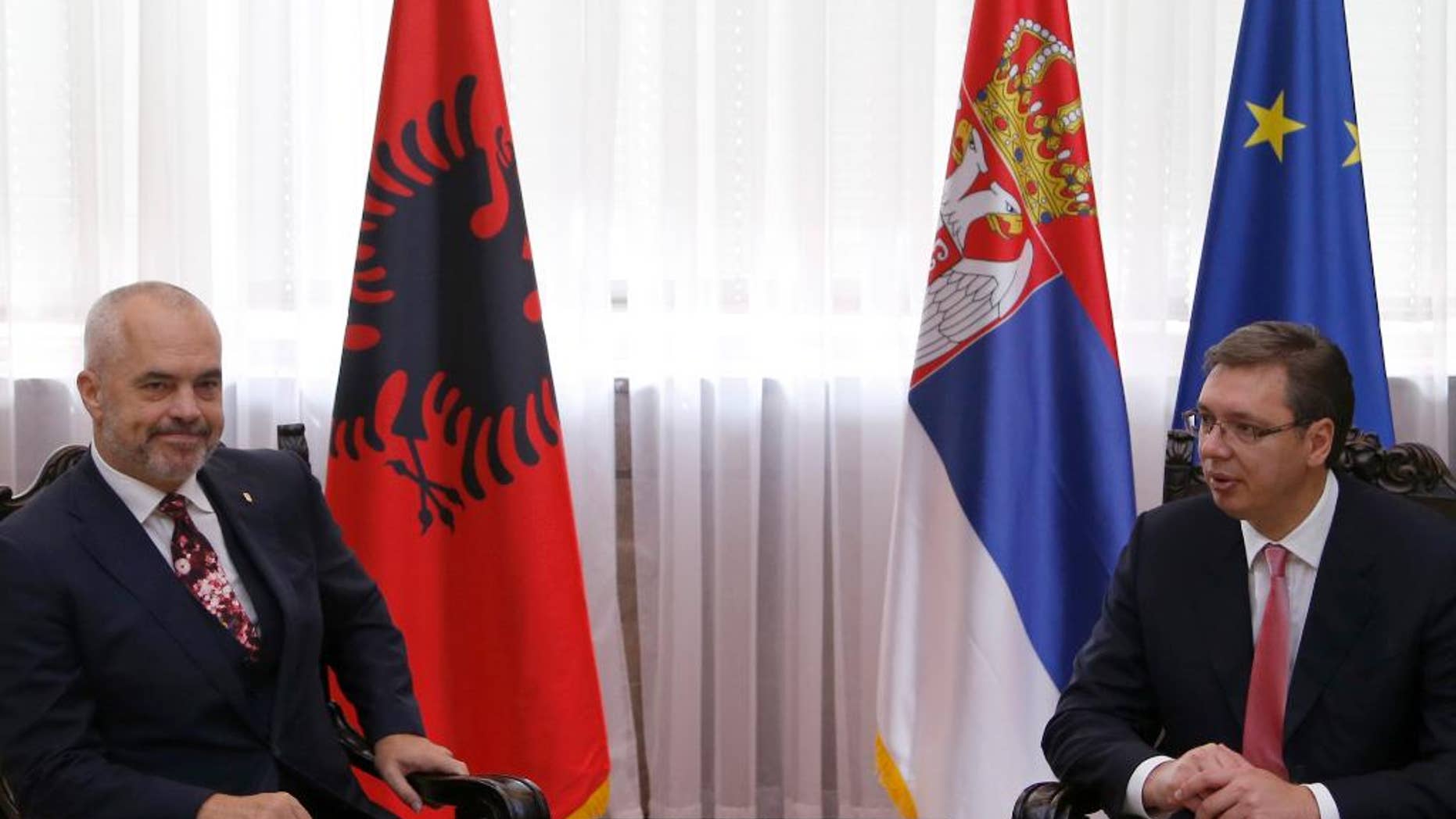 FILE - In this Thursday, Oct. 13, 2016 file photo, Serbian Prime Minister Aleksandar Vucic, right, speaks with his Albanian counterpart Edi Rama in Belgrade, Serbia. Serbian officials warned on Friday, April 21, 2017 of another war in the Balkans if Albanians try to form a joint state with Kosovo in the war-weary European region and the West does not reject such a plan. (AP Photo/Darko Vojinovic, File)