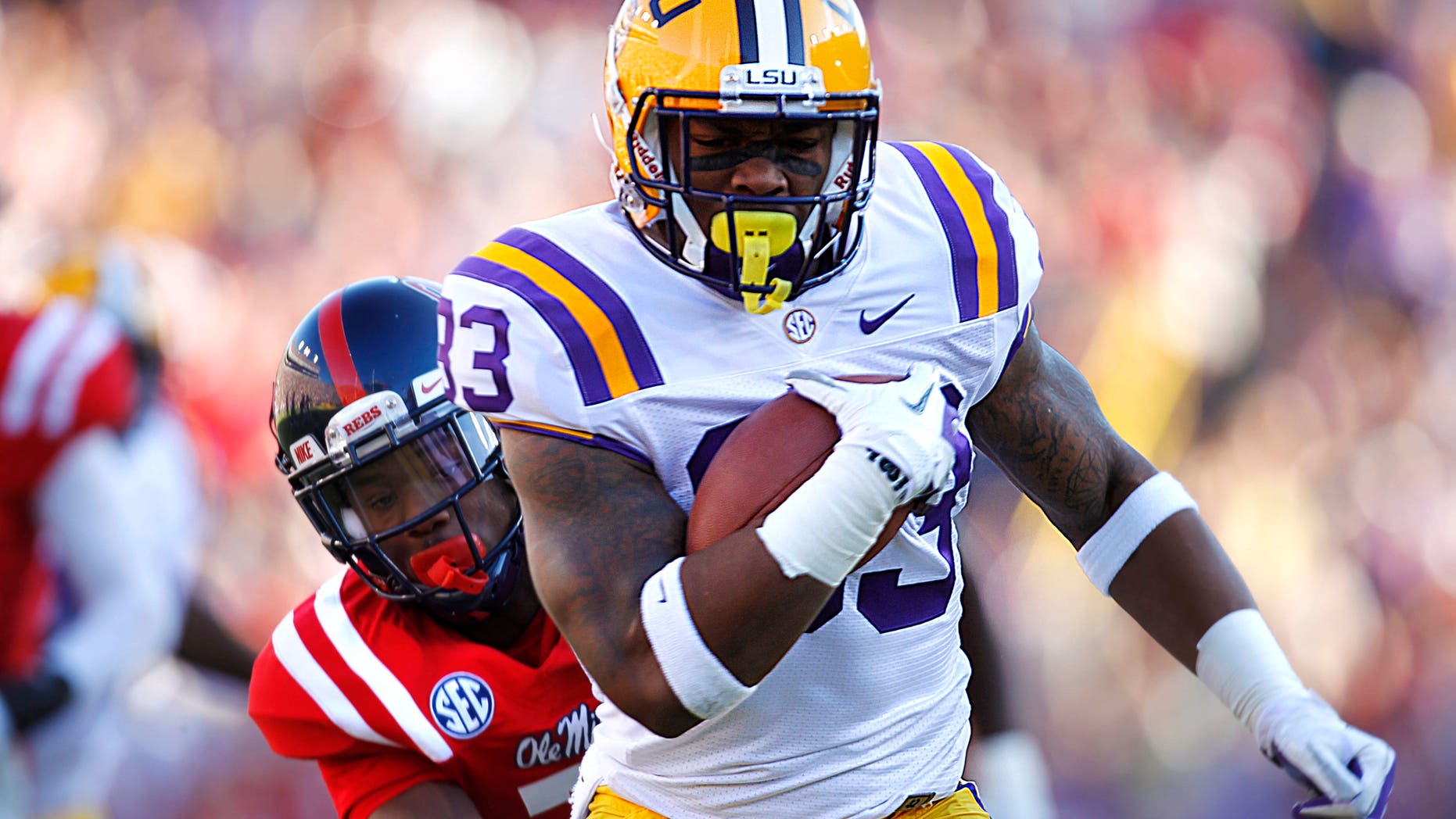 FILE - In this Nov. 17, 2012, file photo, LSU running back Jeremy Hill (33) rushes past Mississippi defensive back Trae Elston (7) on a 27-yard touchdown carry during the first half of their NCAA college football game in Baton Rouge, Hill, already serving two years' probation in connection with a 2011 arrest, was arrested again early Saturday morning, April 27, 2013, after allegedly punching another man in the side of the head outside a Baton Rouge bar near campus. (AP Photo/Gerald Herbert)