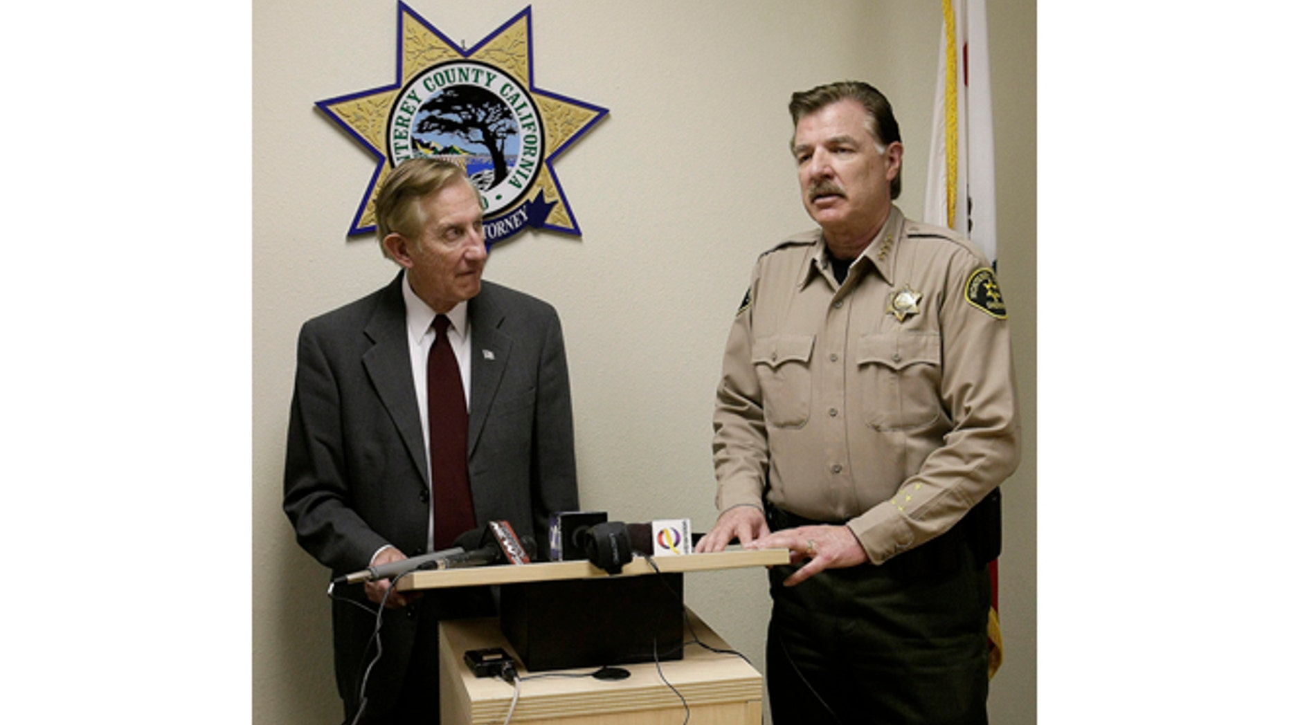 Monterey County District attorney Dean Flippo, left, and Monterey County Sheriff Scott Miller answer questions during a news conference, Tuesday, Feb. 25, 2014, in Salinas, Calif. Flippo said the six officers, including the recently retired police chief and the acting chief, have been arrested, in connection to a scheme to steal more than 200 cars from poor Hispanic people. (AP Photo/The Monterey County Herald, Vern Fisher)