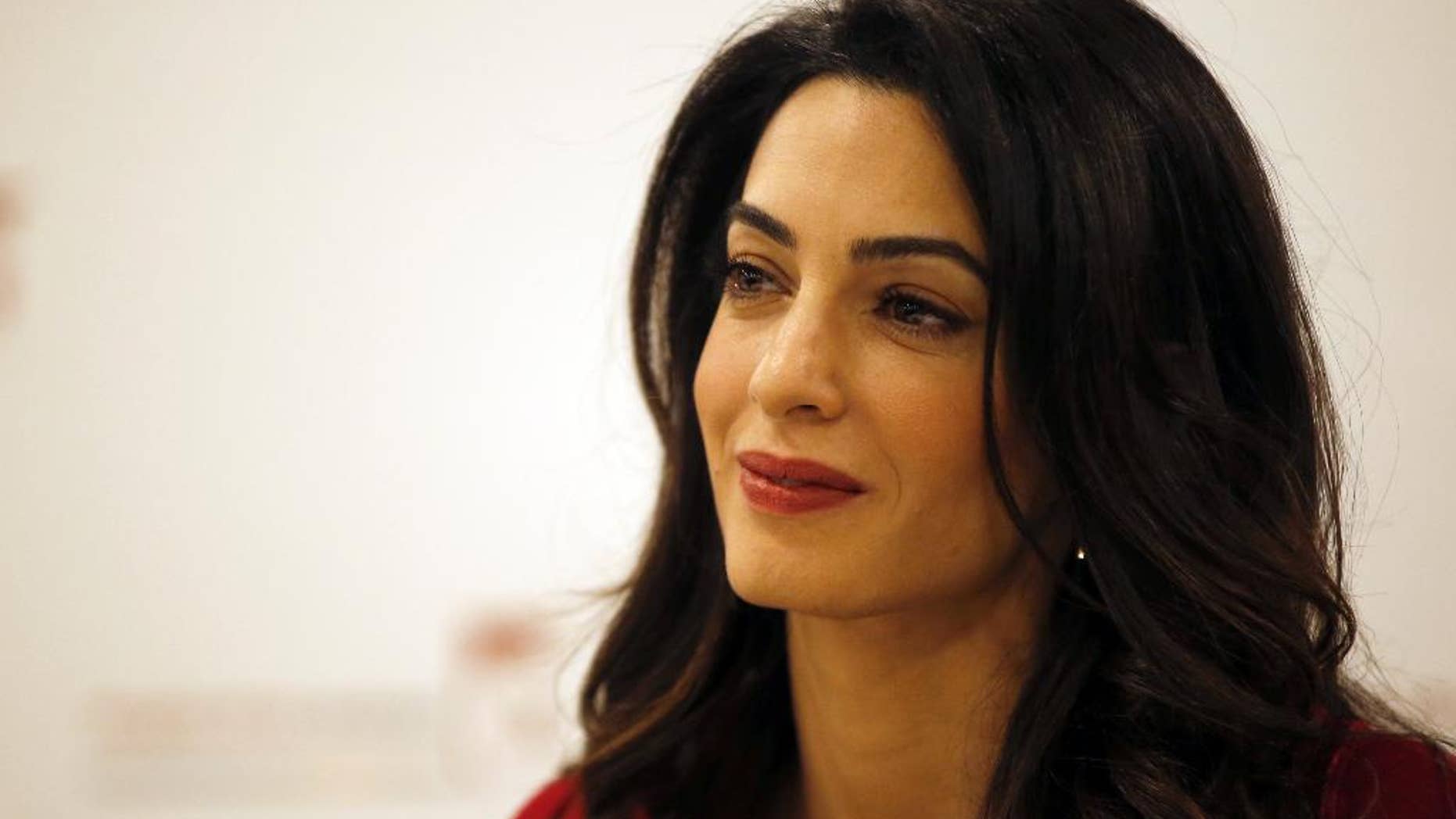 FILE - In this Jan. 25, 2016, file photo, British lawyer Amal Clooney attends a press conference with former Maldives president Mohamed Nasheed in London. Clooney is pushing for the United Nations to investigate and prosecute Islamic State commanders for genocide. Clooney wants IS leaders tried over the killings. The British lawyer appeared on NBC’s “Today” show in an interview broadcast Monday, Sept. 19, 2016, alongside 23-year-old Nadia Murad, a Yazidi woman who escaped after being captured by IS in 2014. (AP Photo/Alastair Grant, File)