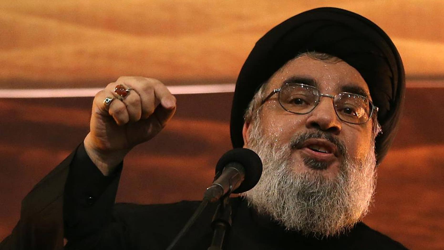 FILE - In this November 3, 2014, file photo, Hezbollah leader Sheikh Hassan Nasrallah addresses supporters ahead of the Shiite Ashura commemorations in the southern suburb of Beirut, Lebanon. The leader of the Lebanese militant Hezbollah group has confirmed that a senior operative in the organization has been apprehended for spying for Israel. The confirmation from Nasrallah comes weeks after local newspapers published unconfirmed reports that a high-level Hezbollah member had been spying for Israel, and identified the man as Mohammad Shorba. (AP Photo/Hussein Malla, File)