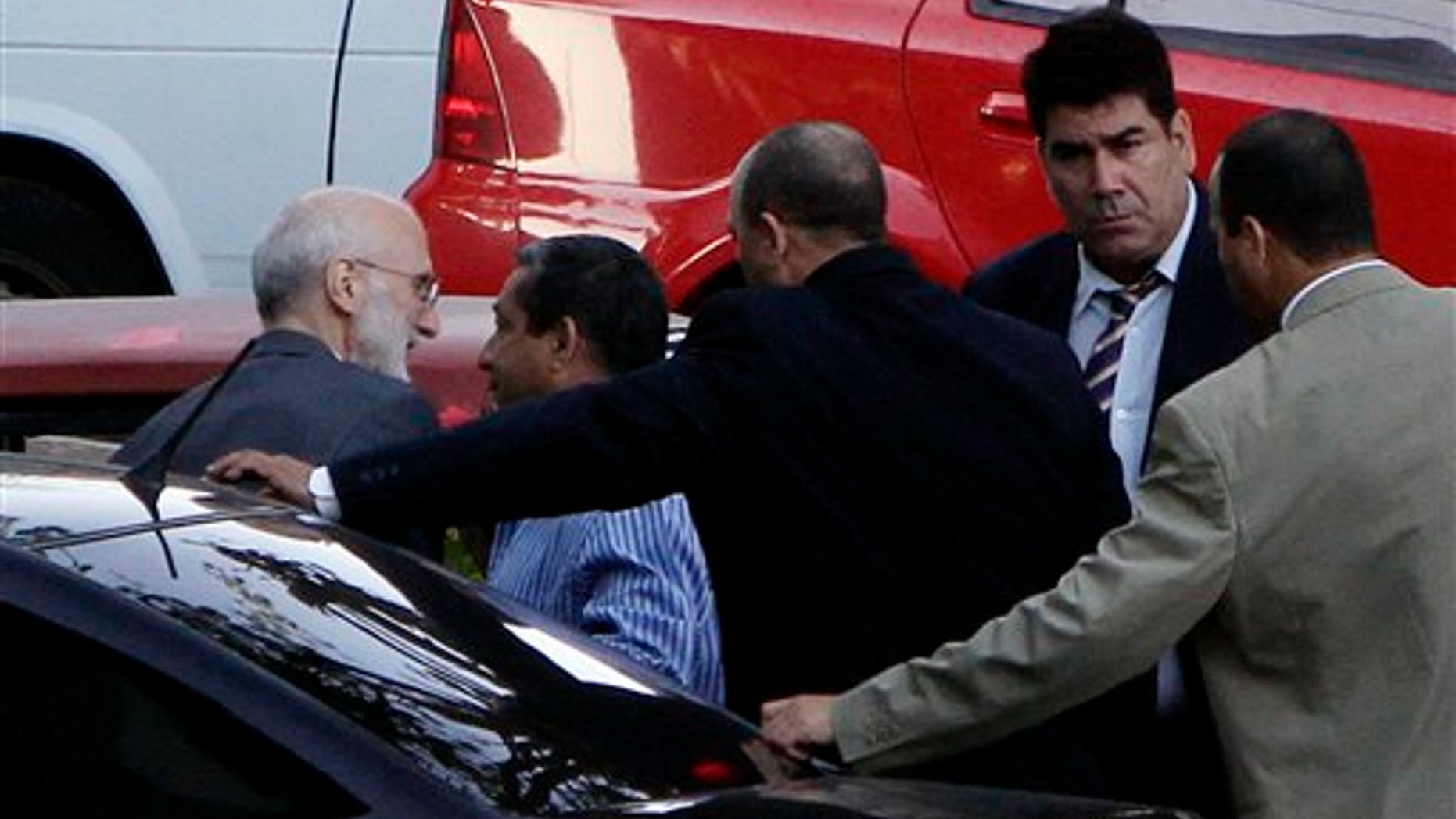Followed by security forces members, U.S. government contractor Alan Gross, left, arrives to a courthouse to attend a trial in Havana, Cuba, Saturday March 5, 2011. Gross, a 61-year-old Maryland native, was arrested in December 2009, accused of illegally bringing communications equipment into Cuba for Development Associates International as part of a USAID-backed democracy program. (AP Photo/Franklin Reyes)