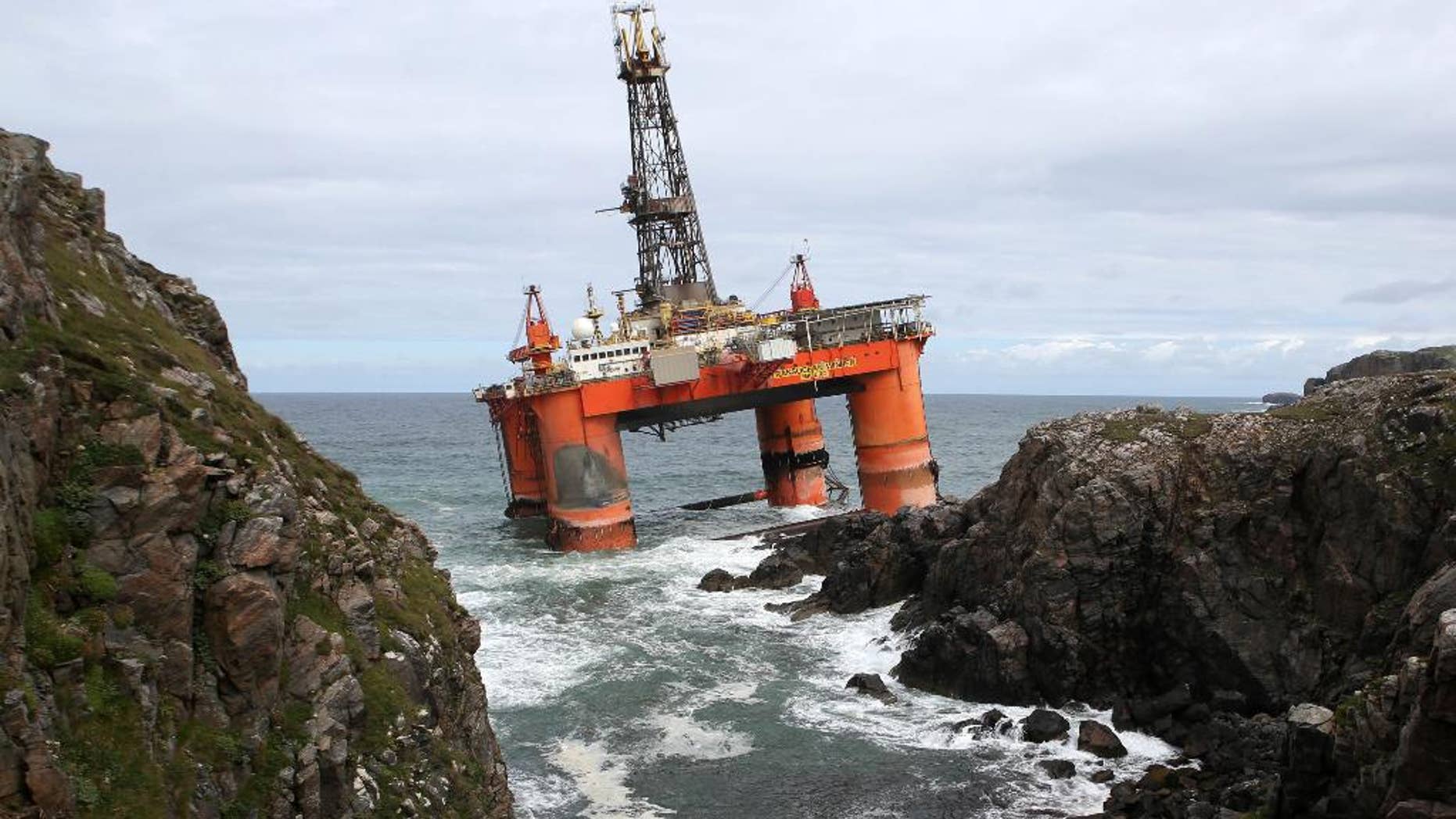 FILE - In this file photo dated Oct. 9, 2016, showing the Transocean Winner drilling rig as it broke free from tug boats in rough seas and ran aground off the Isle of Lewis, Outer Hebrides, Scotland. Final preparations are being made for high tide on Monday Aug. 22, 2016, to re-float the 17,000-tonne oil rig carrying some 280 tons of diesel on board. (Andrew Milligan / PA FILE via AP)