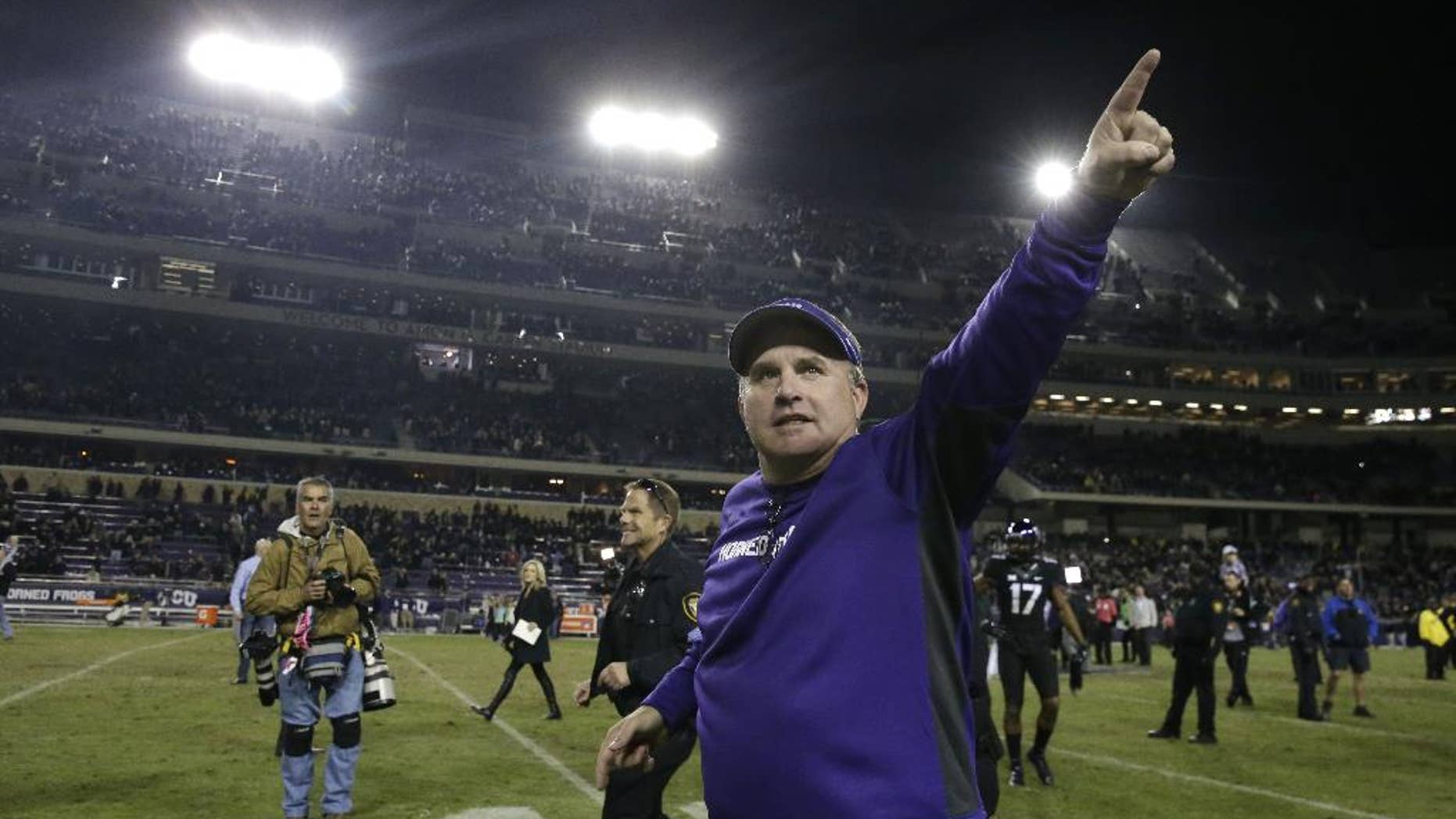 TCU head coach Gary Patterson points to fans as he runs off the field after an NCAA college football game against Kansas State Saturday, Nov. 8, 2014, in Fort Worth, Texas. TCU won 41-20. (AP Photo/LM Otero)