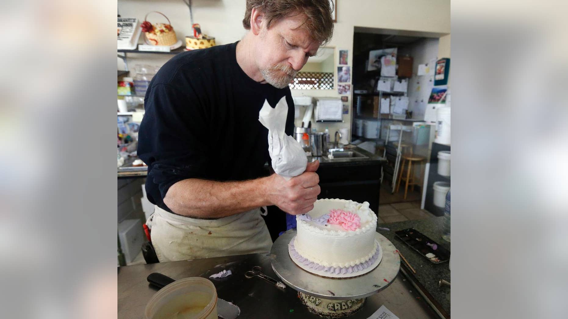 In this March 10, 2014, file photo, Masterpiece Cakeshop owner Jack Phillips decorates a cake inside his store in Lakewood, Colo. Colorado's Supreme Court has refused to take up the case of Phillips, who would not make a wedding cake for a same-sex couple. (AP Photo/Brennan Linsley, File)