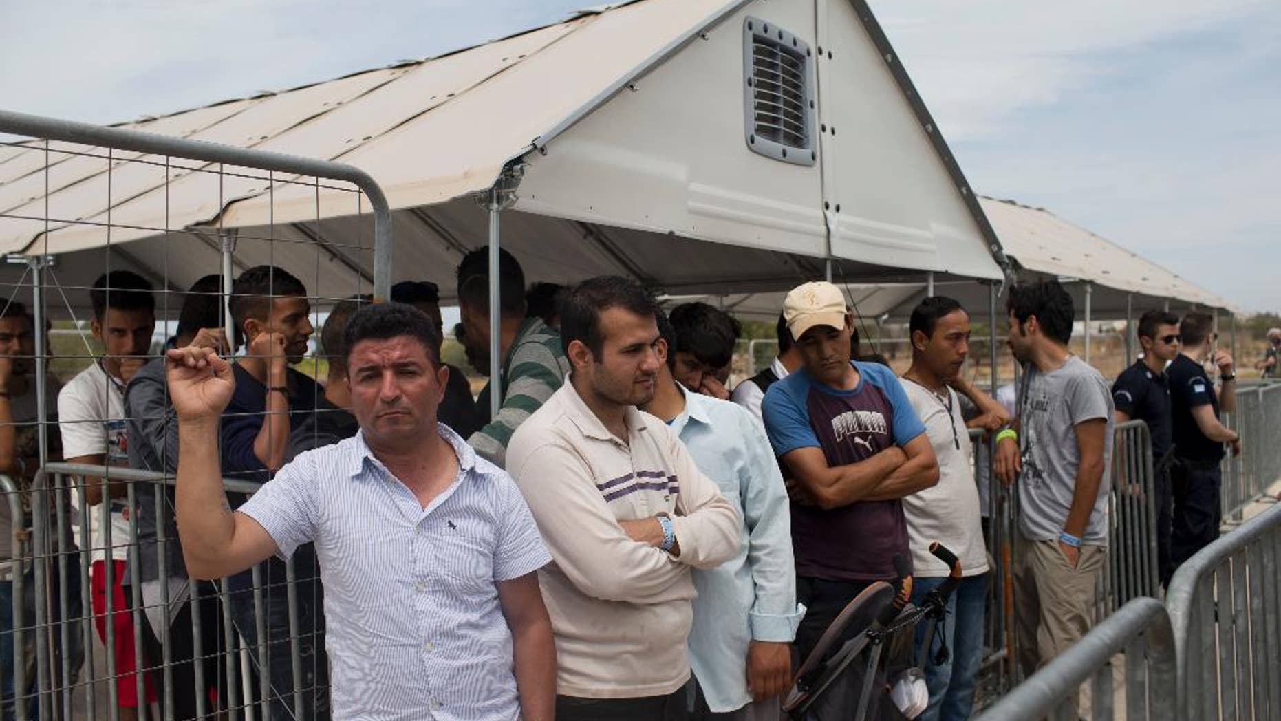 Migrants who live in the Hellenikon refugee and migrant camp of Athens wait to register for asylum on Monday, June 13, 2016. Authorities began registering applications at the site Monday, in a processes expected to last months as more than 50,000 migrants and refugees have been stranded in Greece in the wake of European border closures. (AP Photo/Petros Giannakouris)