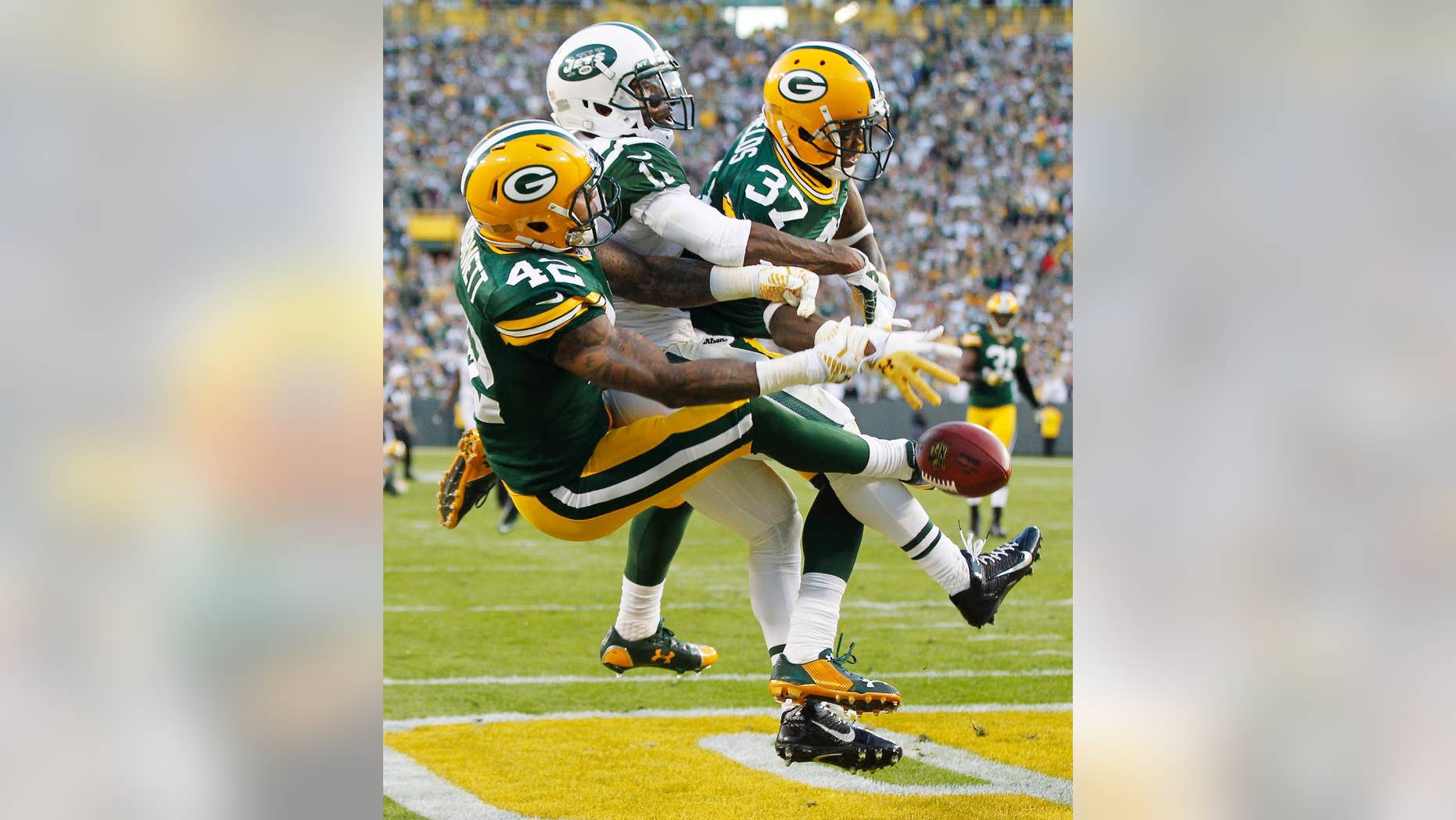 Green Bay Packers' Sam Shields (37) and Morgan Burnett break up a pass intended for New York Jets' Jeremy Kerley during the second half of an NFL football game Sunday, Sept. 14, 2014, in Green Bay, Wis. (AP Photo/Mike Roemer)