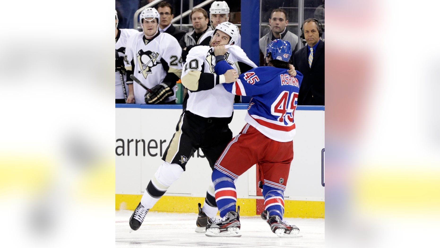 Pittsburgh Penguins' Tanner Glass, left, and New York Rangers' Arron Asham fight during the opening seconds of the first period of the NHL hockey game in New York, Sunday, Jan. 20, 2013. (AP Photo/Seth Wenig)