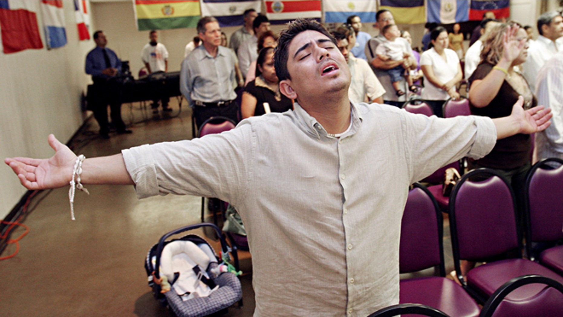 MESA, AZ - APRIL 9: Charlie Anaya, of Phoenix, prays during the worship service at Iglesia Palabra de Vida April 9, 2006 in Mesa, Arizona. There are approximately 300 evangelical Hispanic churches with 15,000 members in the Phoenix area that have been instrumental in organizing for immigrants rights. (Photo by Jeff Topping/Getty Images)