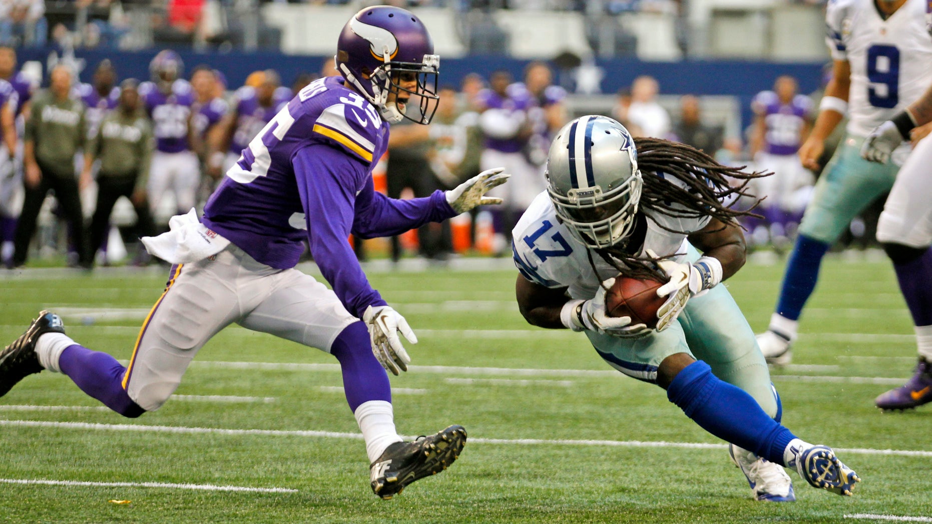 Minnesota Vikings' Marcus Sherels (35) is unable to keep Dallas Cowboys' Dwayne Harris (17) out of the end zone as Cowboys quarterback Tony Romo (9) watches from behind during the second half of an NFL football game, Sunday, Nov. 3, 2013, in Arlington, Texas. The Cowboys won 27-23. (AP Photo/Tim Sharp)