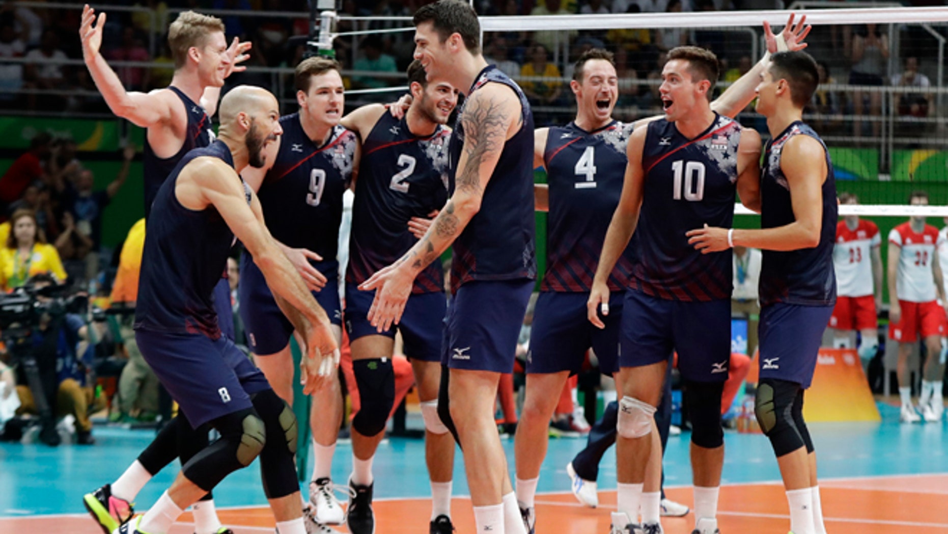 The United States volleyball team celebrates a victory over Poland in a men's quarterfinal volleyball match at the 2016 Summer Olympics in Rio de Janeiro, Brazil, Wednesday, Aug. 17, 2016.