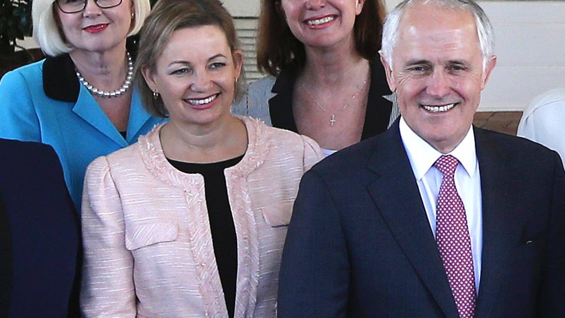 FILE - In this Sept. 21, 2015, file photo, Australia's Health Minister Sussan Ley, left in foreground, poses with Prime Minister Malcolm Turnbull, right, for a group photo after they were sworn in at Government House in Canberra, Australia. Ley stood aside while her travel expense claims are investigated. The scandal surrounding Ley's expense claims could trigger the first reshuffle of Turnbull's Cabinet since his government was re-elected in July 2106. Turnbull said Ley had agreed to stand aside on Monday, Jan. 9, 2017 without ministerial pay while the prime minister's department investigated whether her expense claims met guidelines. (AP Photo/Rob Griffith, File)