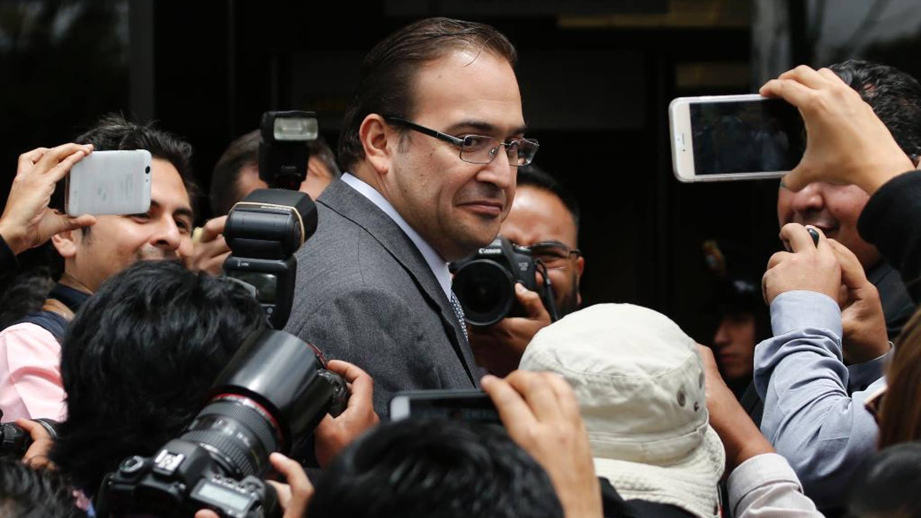 FILE - In this Aug. 5, 2016 file photo, outgoing Veracruz Gov. Javier Duarte arrives to the Attorney General's headquarters in Mexico City. Head of the office's branch for investigating federal crimes said in comments published online by the Attorney General's Office late Wednesday, Sept. 21, 2016, that it has taken over two corruption investigations involving Duarte. (AP Photo/Marco Ugarte, File)
