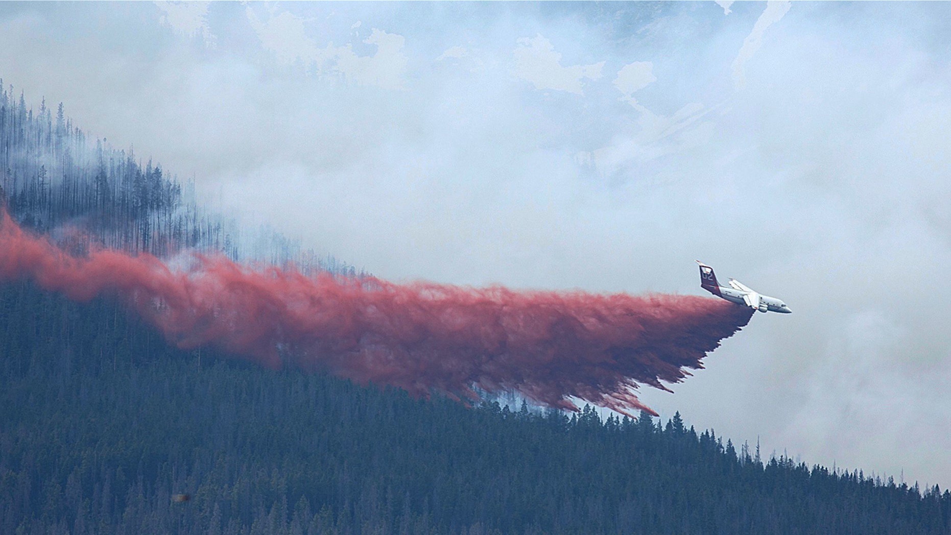 A plane drops fire retardant in Breckenridge, Colo., Wednesday, July 5, 2017.