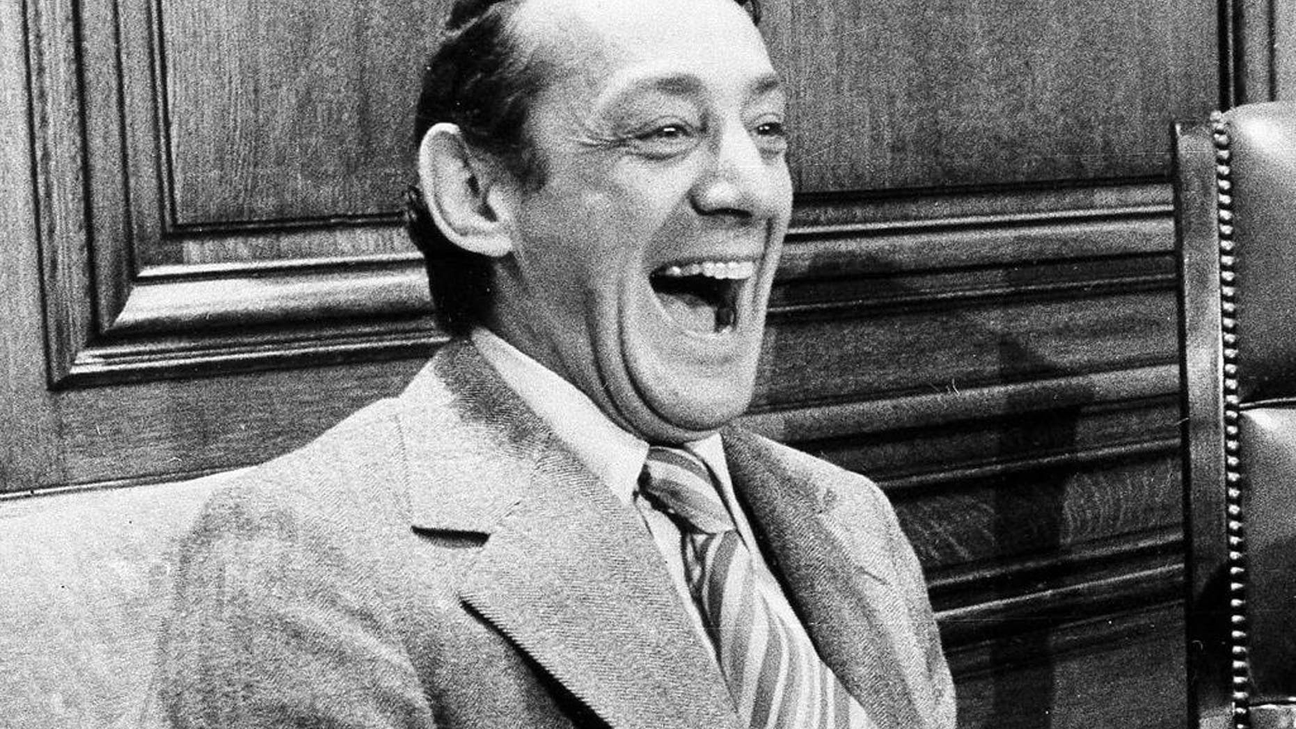 FILE - In this April 1977 file photo, San Francisco supervisor Harvey Milk sits in the mayor's office during the signing of the city's gay rights bill in San Francisco. The late gay rights leader Milk already has schools, streets and parks named in his honor. Soon, a U.S. Navy ship will join the list. A Navy official said Friday, July 29, 2016, that Navy Secretary Ray Mabus notified Congress earlier this month that a new fleet of replenishment oilers being built in San Diego will be named for Milk and five other civil and human rights icons. (AP Photo/File)