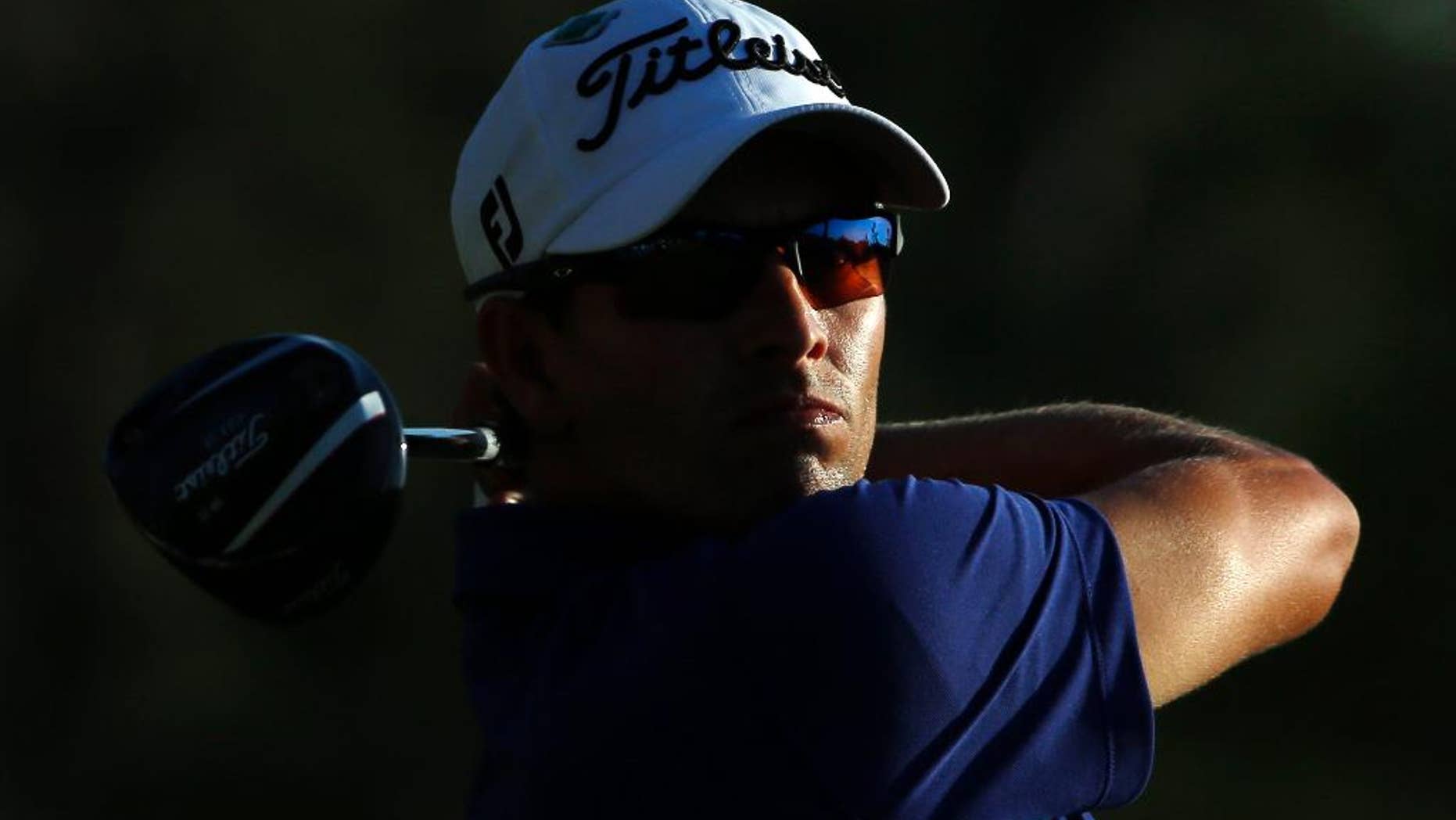 Adam Scott, of Australia, tees off during the third round of the Masters golf tournament Saturday, April 12, 2014, in Augusta, Ga. (AP Photo/David J. Phillip)