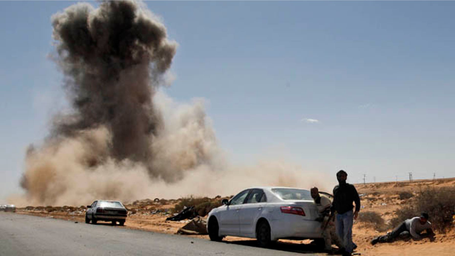 March 7: Smoke raises following an airstrike by Libyan warplanes near a checkpoint close to the anti-Libyan Leader Muammar al-Qaddafi rebels checkpoint in the oil town of Ras Lanouf, eastern Libya. (AP)