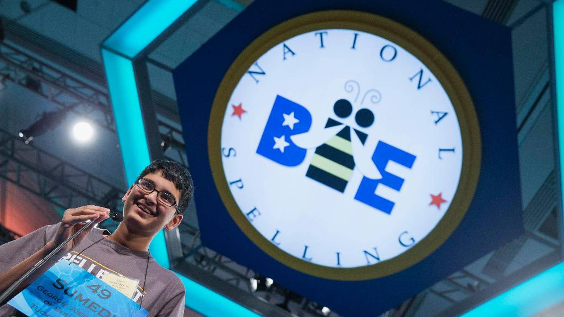 Summedh Garimella of Duluth, Ga., smiles as he spells the word "spelunker" during the preliminary round of the National Spelling Bee, Wednesday, May 28, 2014, in Oxon Hill, Md. (AP Photo/ Evan Vucci)