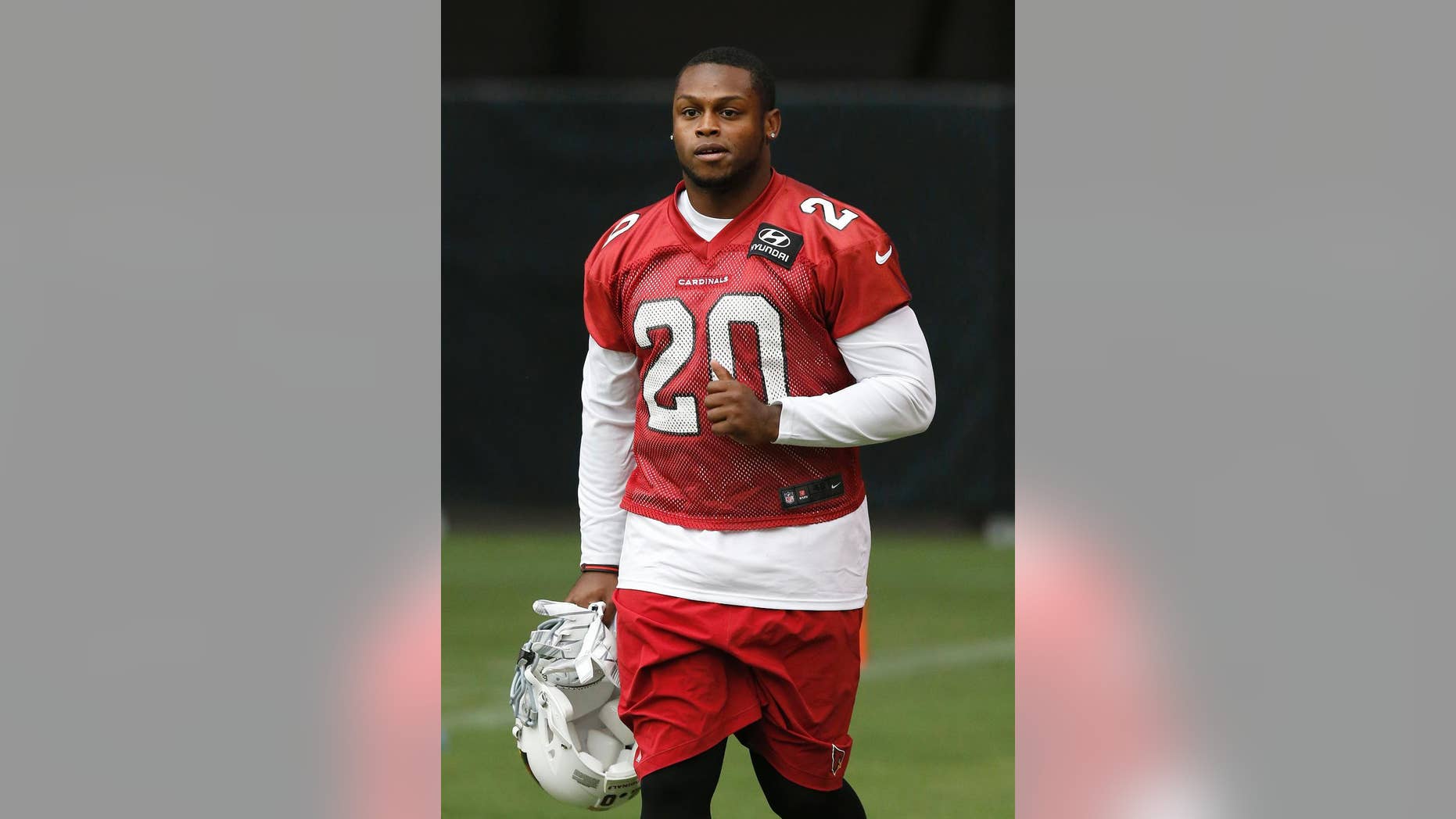 FILE - In this July 26, 2014, file photo, Arizona Cardinals' Jonathan Dwyer runs on the field during the first day of NFL football training camp in Glendale, Ariz. A Phoenix court has lowered the bond used to release Arizona Cardinals running back Jonathan Dwyer from jail after he was arrested on charges that he assaulted his wife during arguments at their apartment. Maricopa County Superior Court Commissioner Jeffrey Rueter on Monday, Oct. 20, 2014, reduced Dwyer's bond from $25,000 to $10,000 and removed a requirement that he wear an ankle monitoring bracelet. (AP Photo/Ross D. Franklin, File)