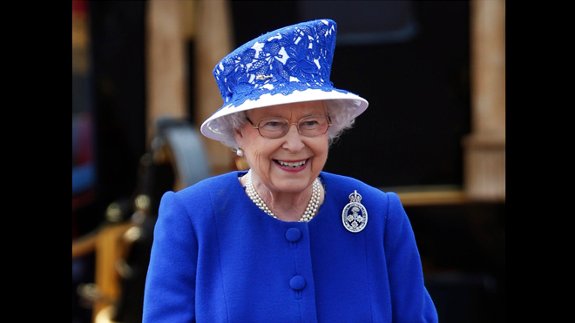 June 15, 2013: Britain's Queen Elizabeth II as the Guards march past outside Buckingham Palace after the Trooping The Colour, at the Horse Guards Parade in London. Queen Elizabeth II is celebrating her birthday with traditional pomp and circumstance, but without her husband by her side.