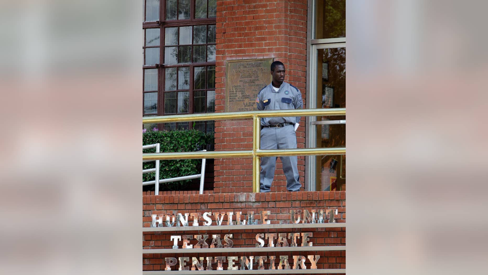 FILE - In this Sept. 21, 2011 file photo, a corrections officer keeps watch outside the Texas Department of Criminal Justice Huntsville Unit in Huntsville, Texas. A two-year dispute about execution drugs in the nation's most active death penalty state is returning to court as Texas seeks to keep secret the identity of whoever provided its drugs for lethal injections before a law last year clamped a firm lid on any supplier's name. (AP Photo/David J. Phillip, File)