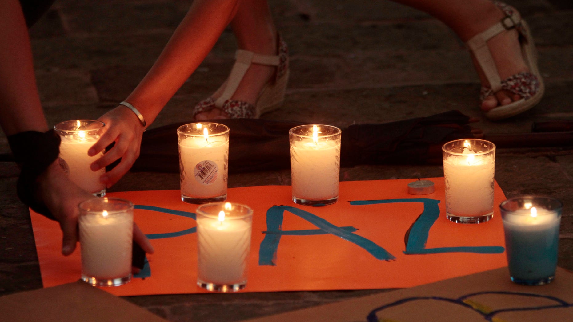 Aug. 26: Protestors place candle holders on top of a banner that reads in Spanish: "Peace" during a demonstration demanding better security following a deadly arson assault, in Monterrey, Mexico.